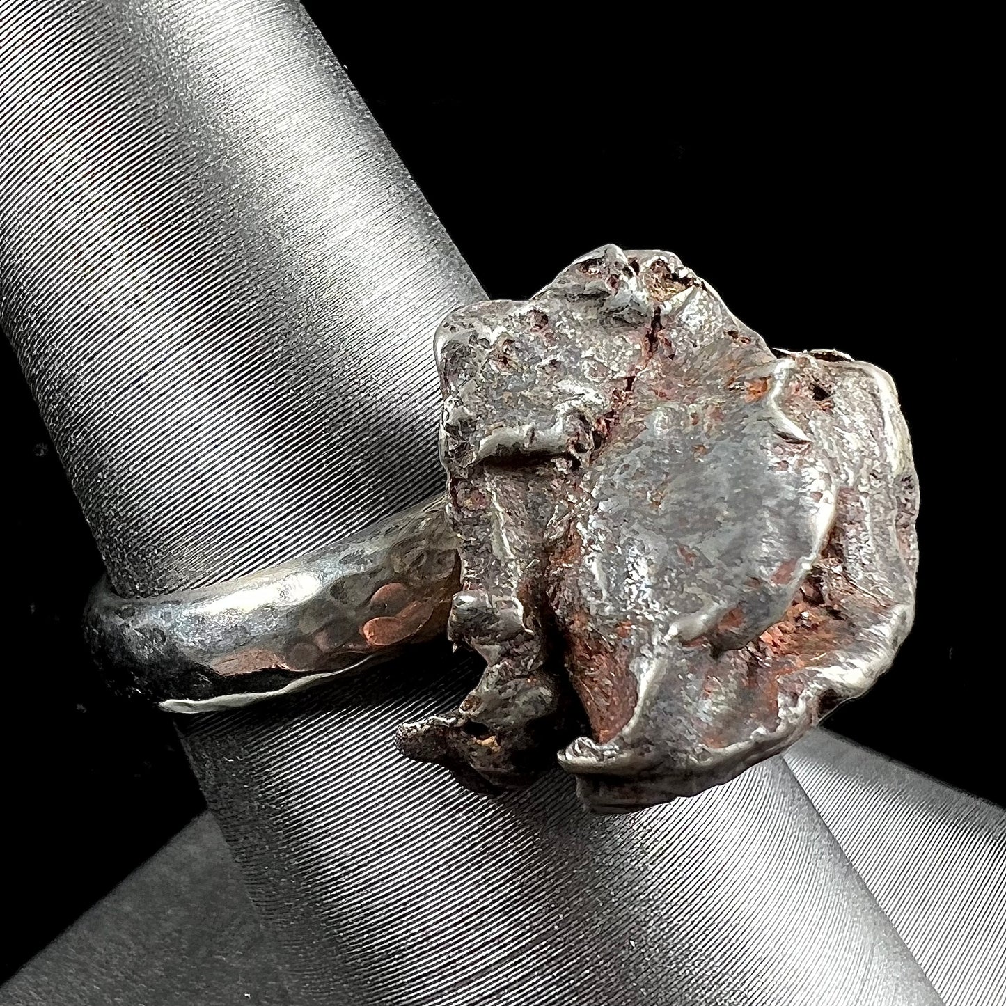 A sterling silver ring set with a Campo del Cielo meteorite.
