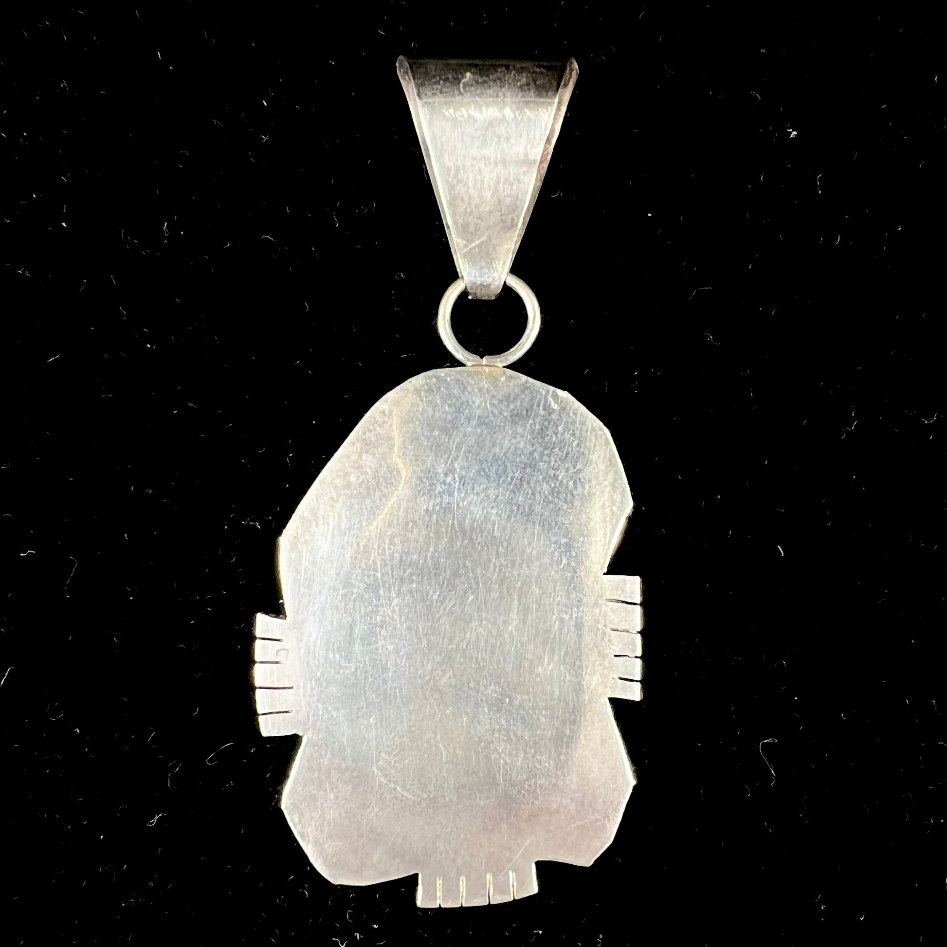 A men's silver Navajo pendant set with a turquoise stone from Pilot Mountain Mine, Nevada.