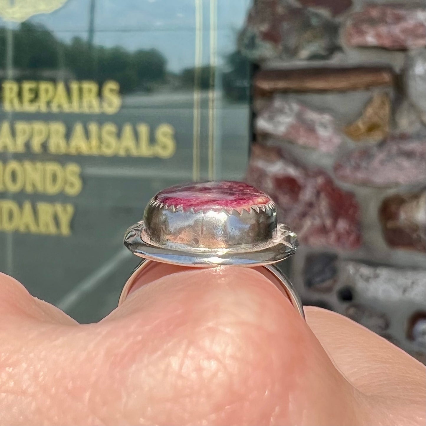 A sterling silver Navajo style ring set with a purple spiny oyster shell.