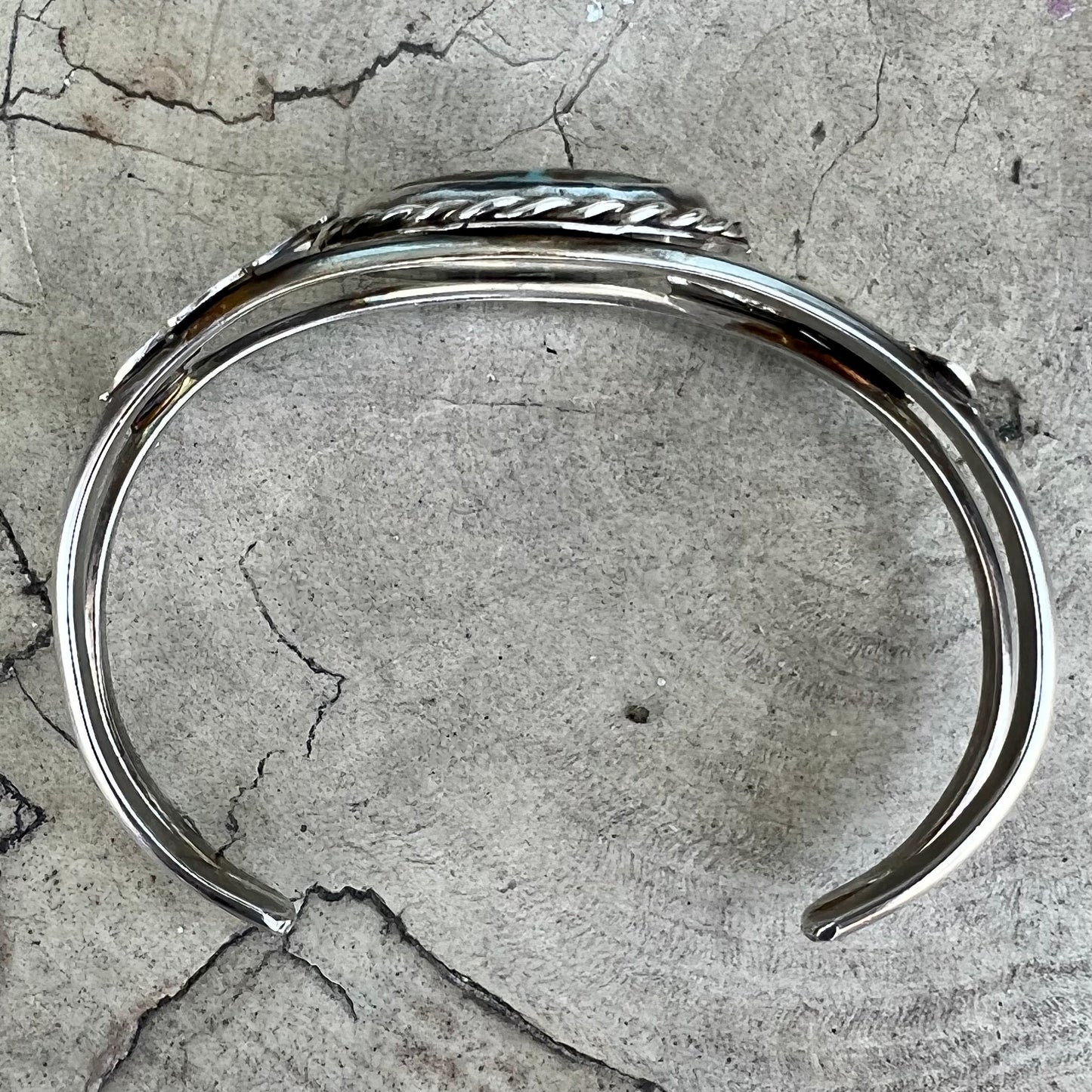 A sterling silver Navajo cuff bracelet set with a Royston turquoise stone.