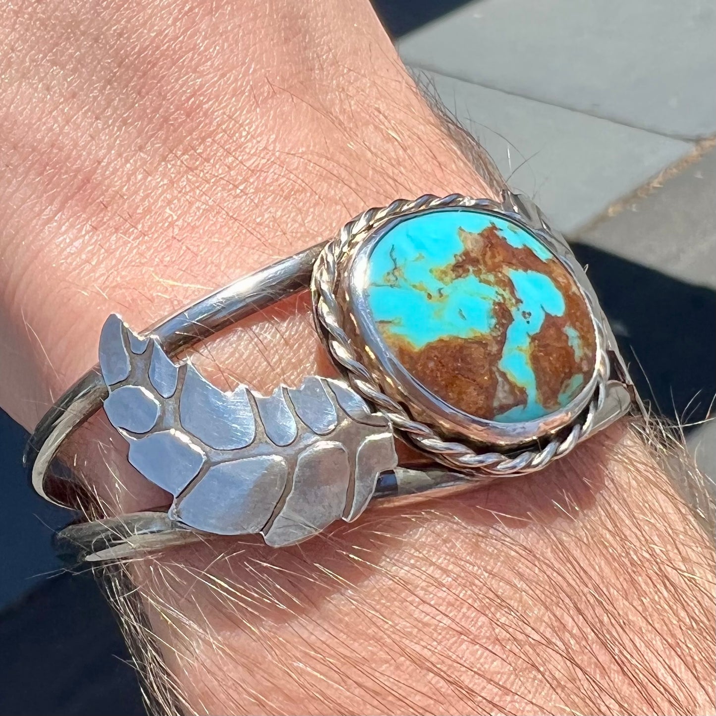 A sterling silver Navajo cuff bracelet set with a Royston turquoise stone.