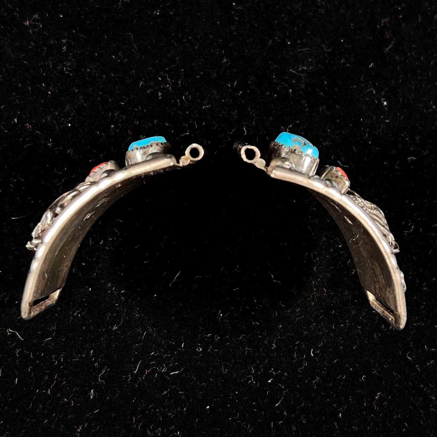 A pair of sterling silver watch cuff parts set with turquoise and coral stones handmade by Navajo artist, Genieve Werito.