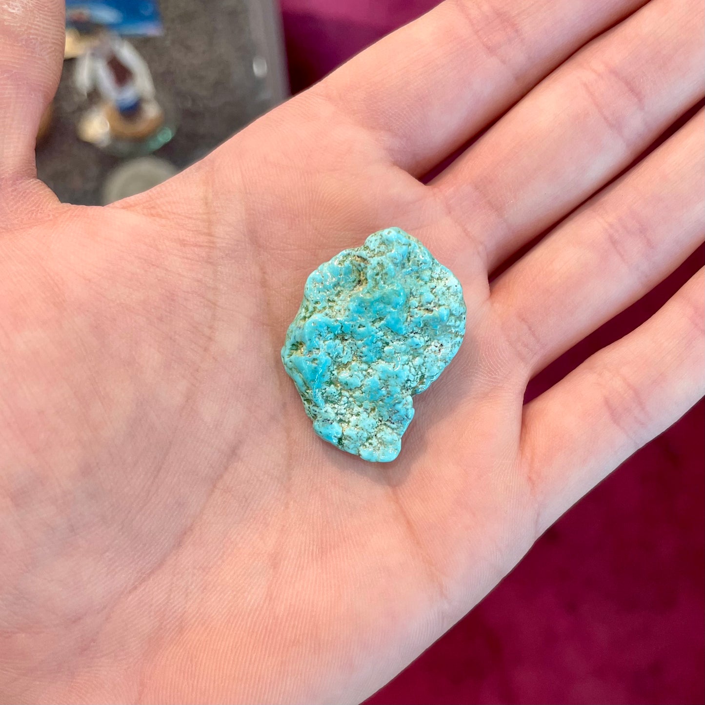 A loose, lightly polished nugget of Sleeping Beauty turquoise.