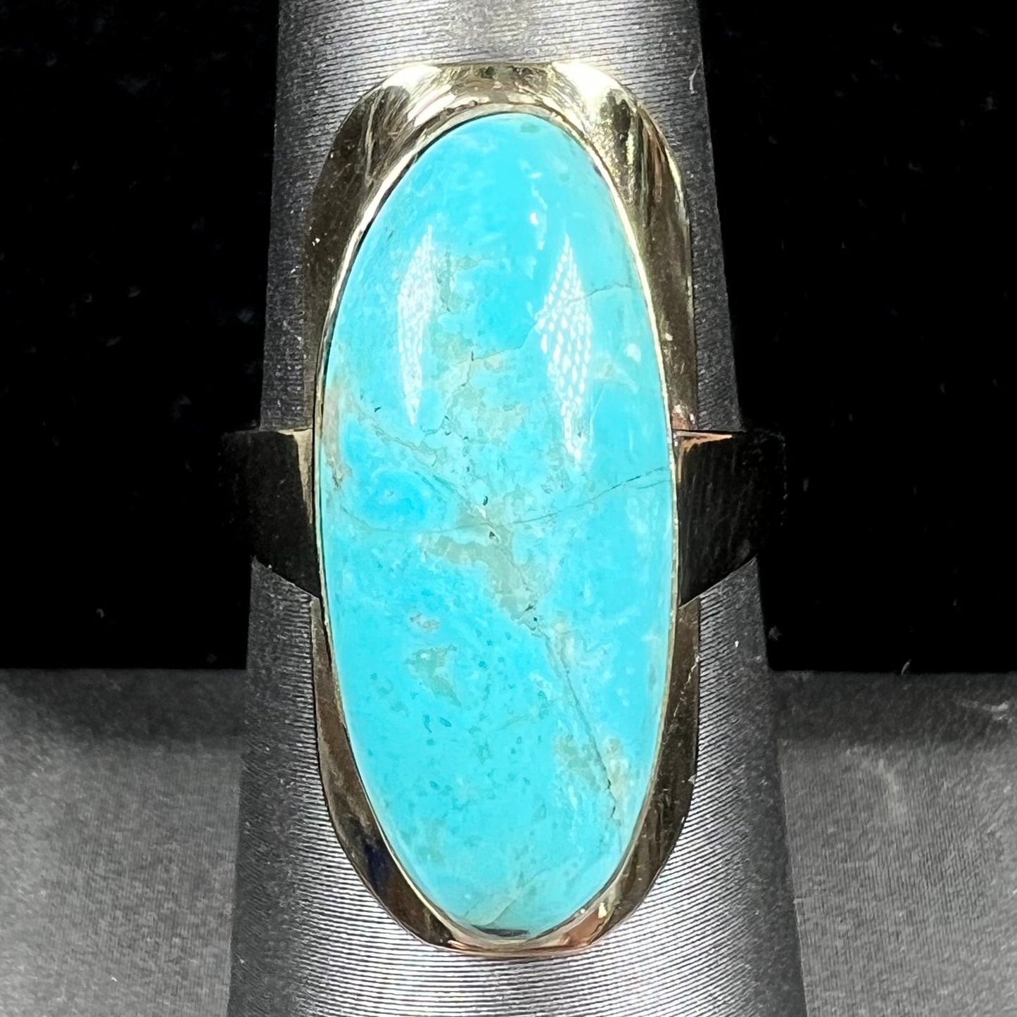 A Sleeping Beauty turquoise solitaire ring cast in 14kt yellow gold.