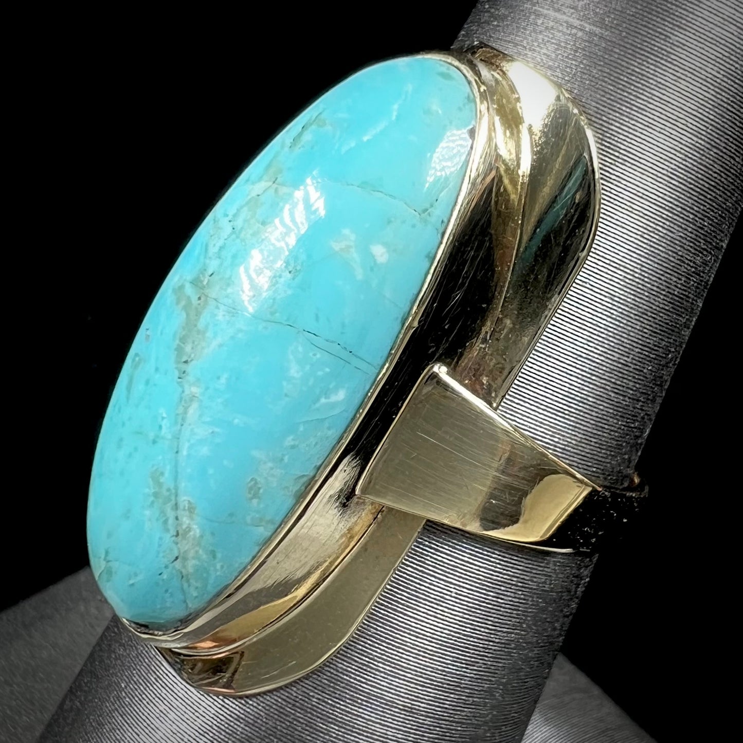 A Sleeping Beauty turquoise solitaire ring cast in 14kt yellow gold.