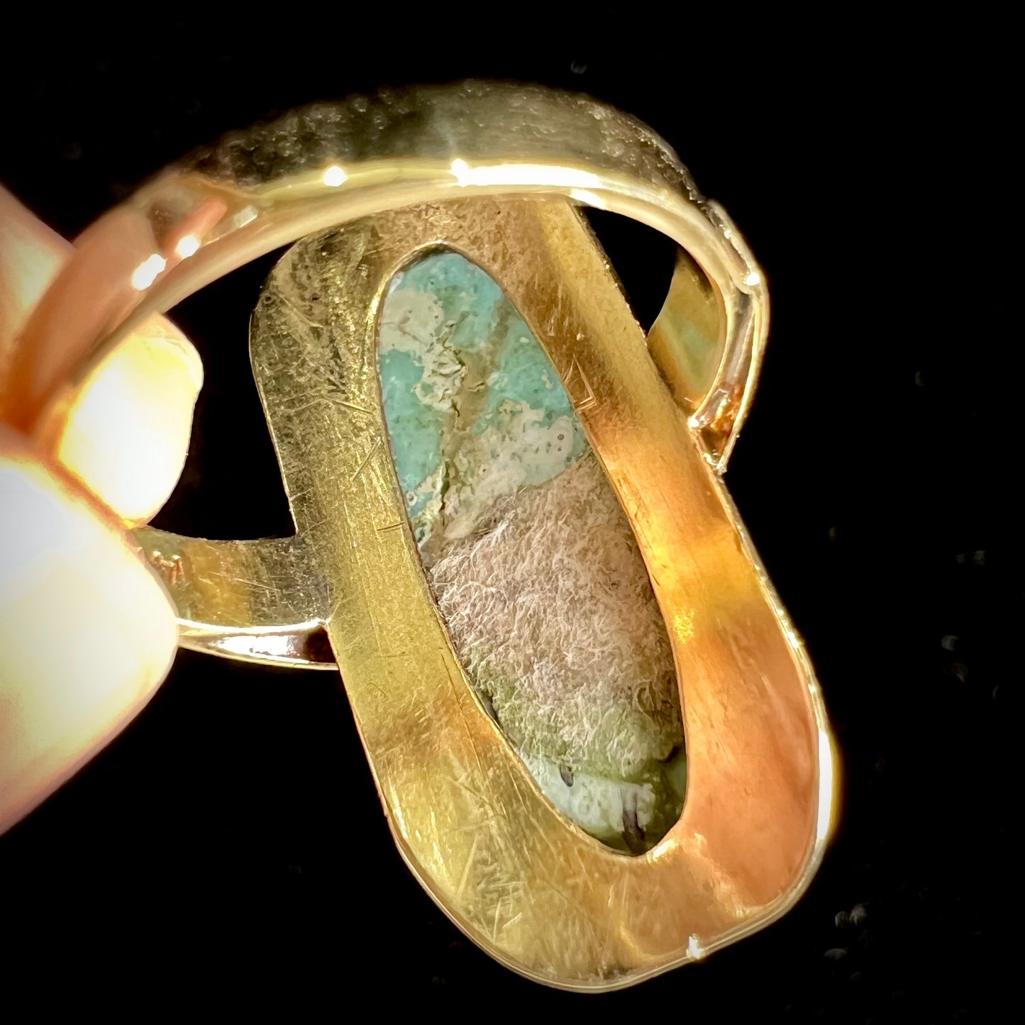 A Sleeping Beauty turquoise solitaire ring cast in 14kt yellow gold.