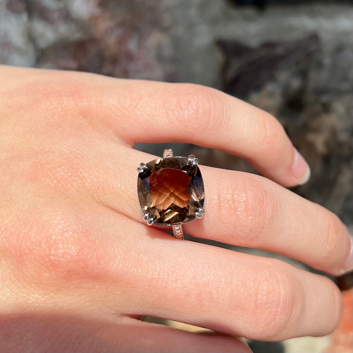 A sterling silver, cushion cut smoky quartz solitaire ring.
