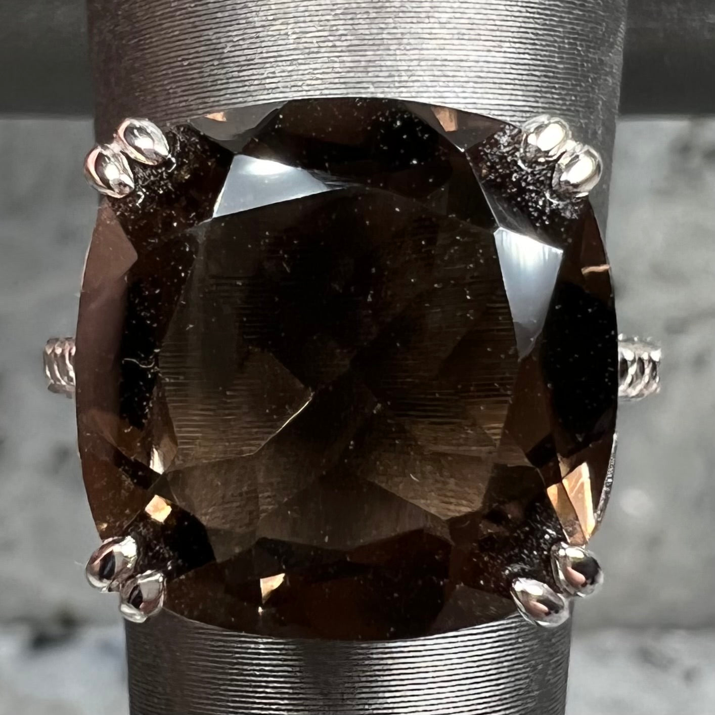 A sterling silver, cushion cut smoky quartz solitaire ring.