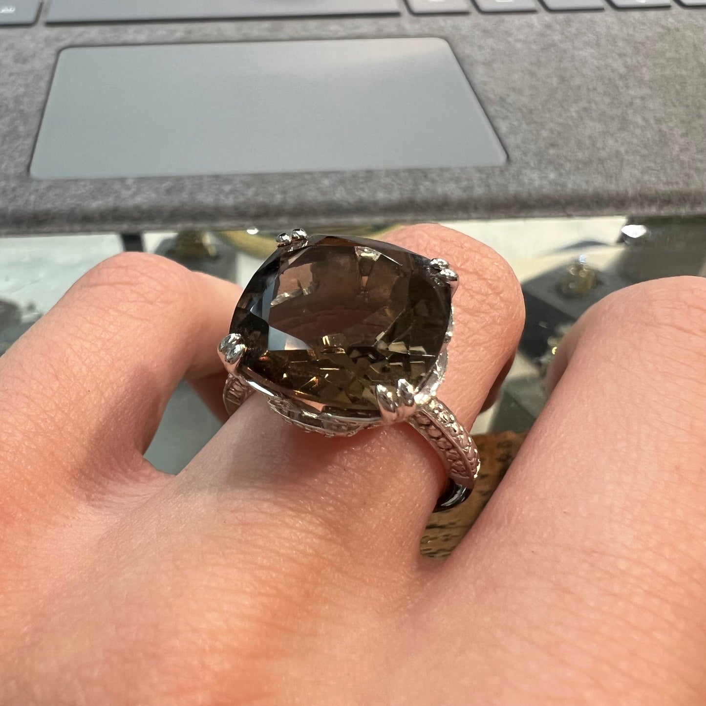 A sterling silver, cushion cut smoky quartz solitaire ring.
