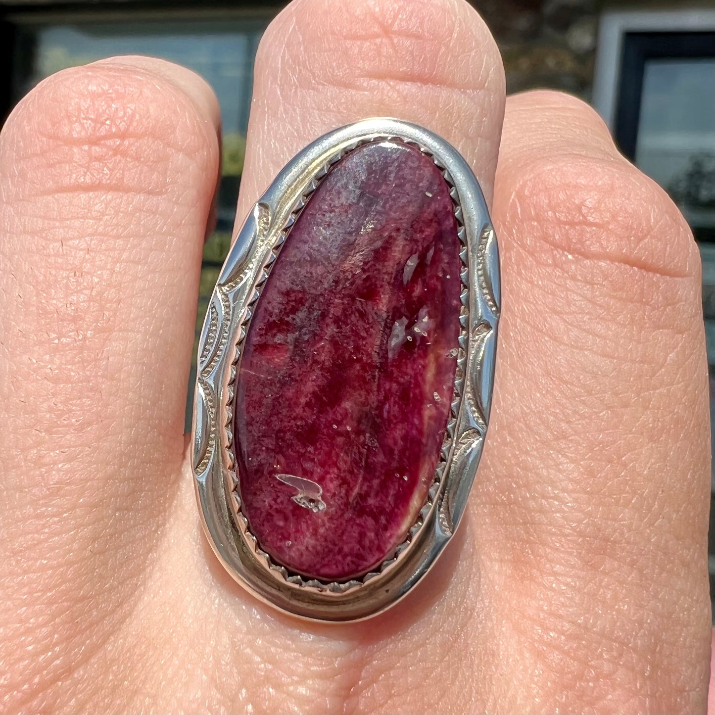 A sterling silver Navajo style ring set with a purple spiny oyster shell.