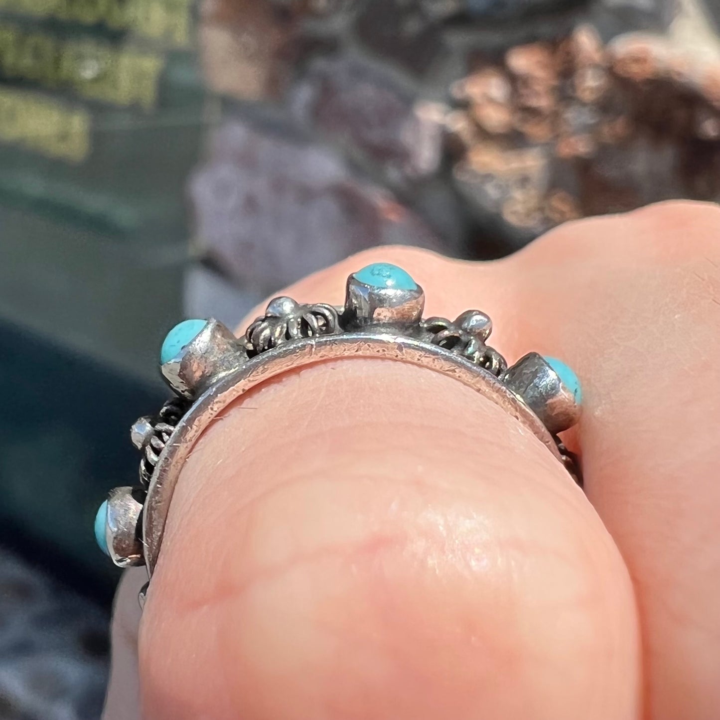 A sterling silver turquoise and flower design eternity band, made in Mexico.