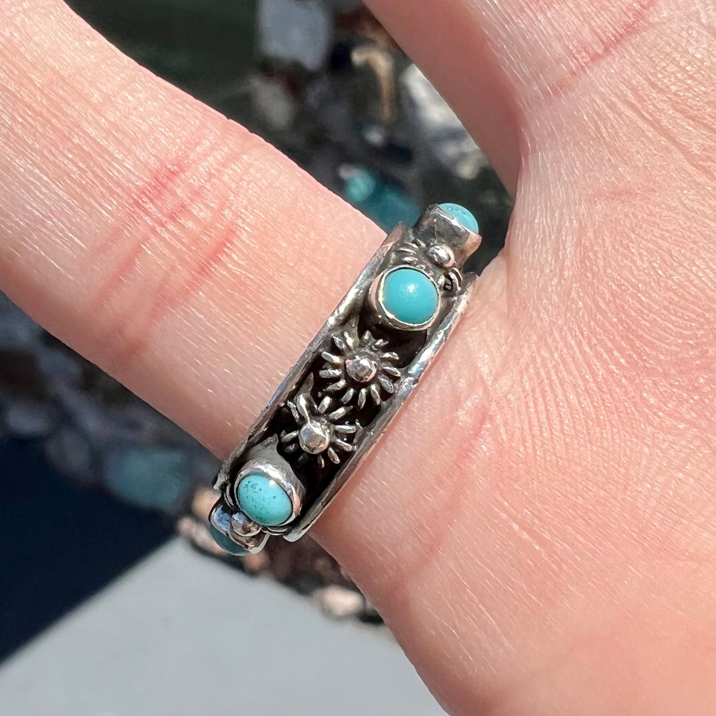 A sterling silver turquoise and flower design eternity band, made in Mexico.