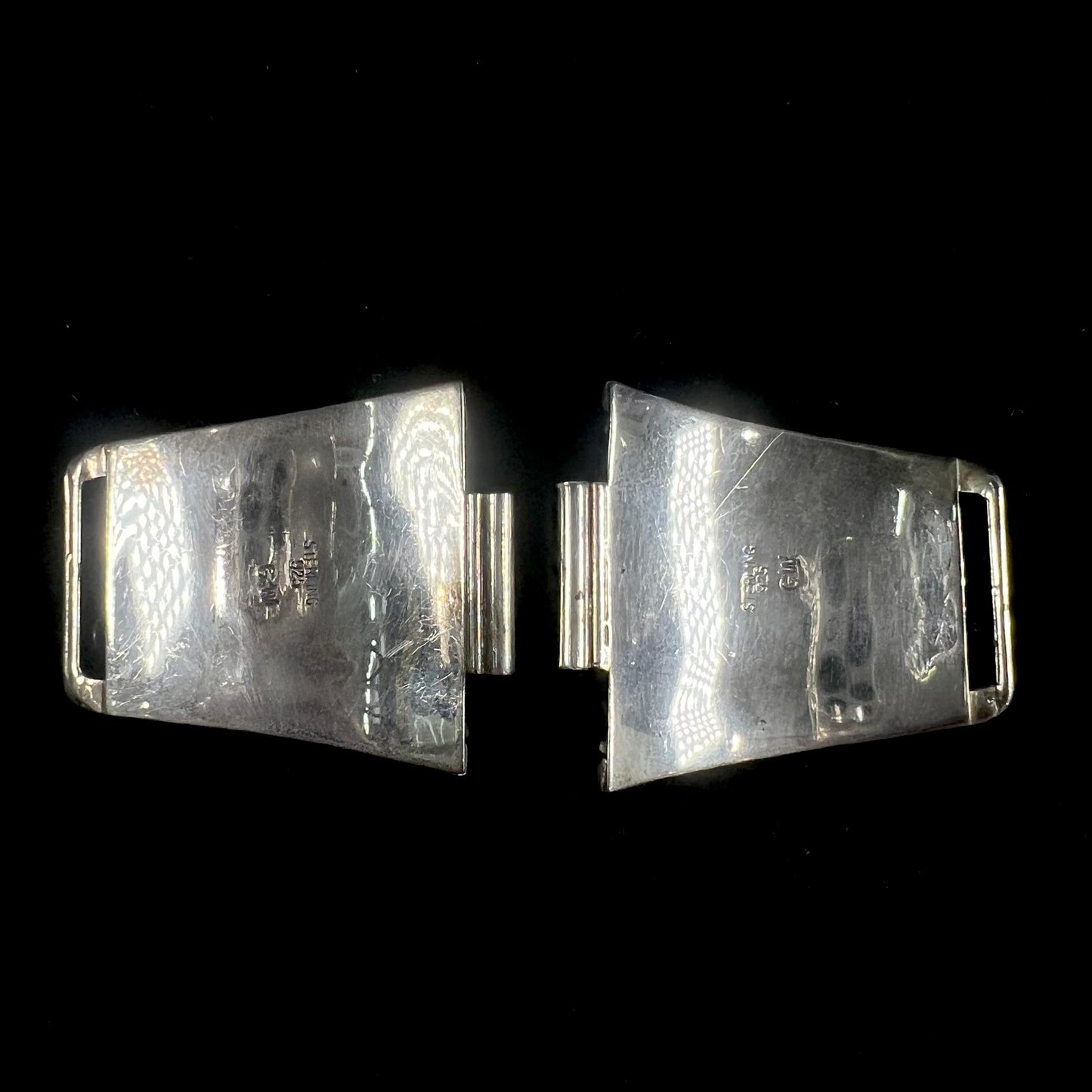 A pair of sterling silver watch cuff parts set with turquoise and coral stones handmade by Navajo artist, Genieve Werito.