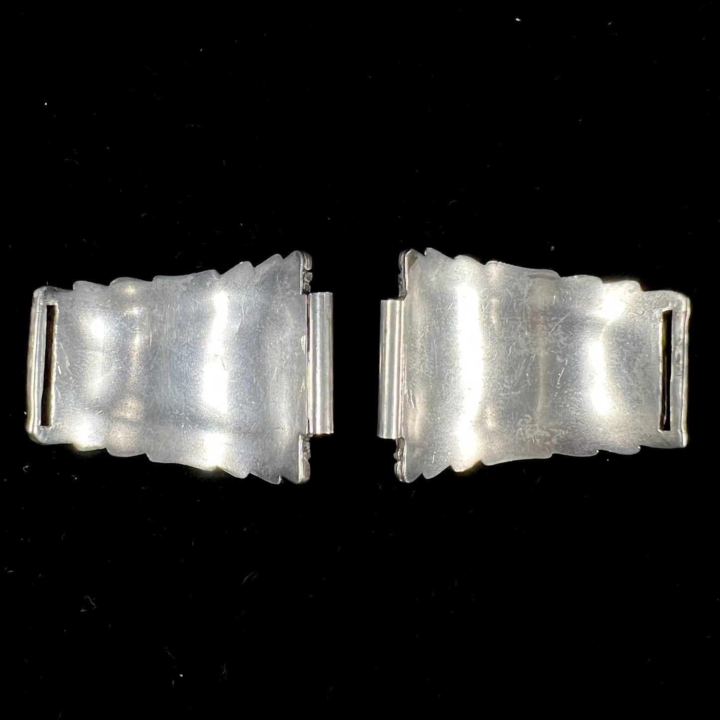 A pair of sterling silver watch cuffs set with turquoise and coral stones.