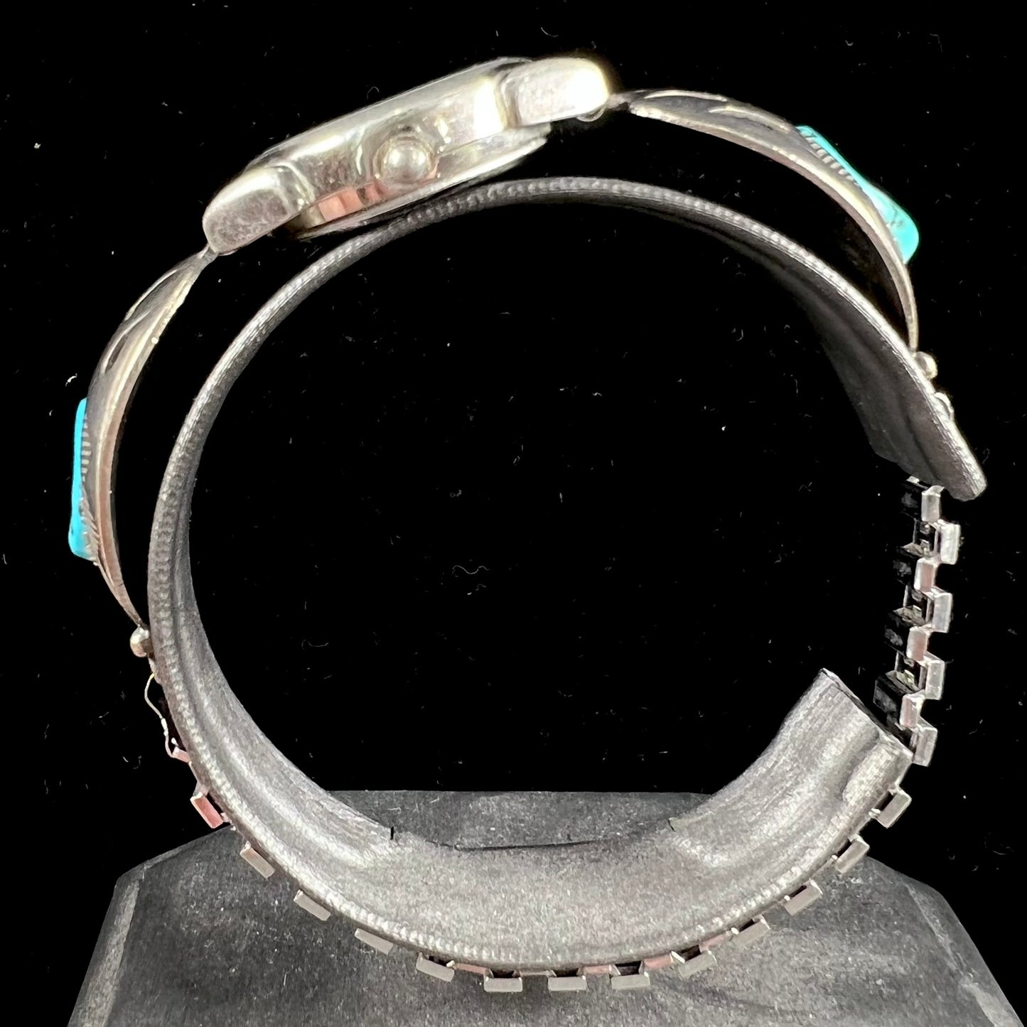 A watch set with two turquoise stones handmade by Navajo artists Arnold and Carleena Goodluck.