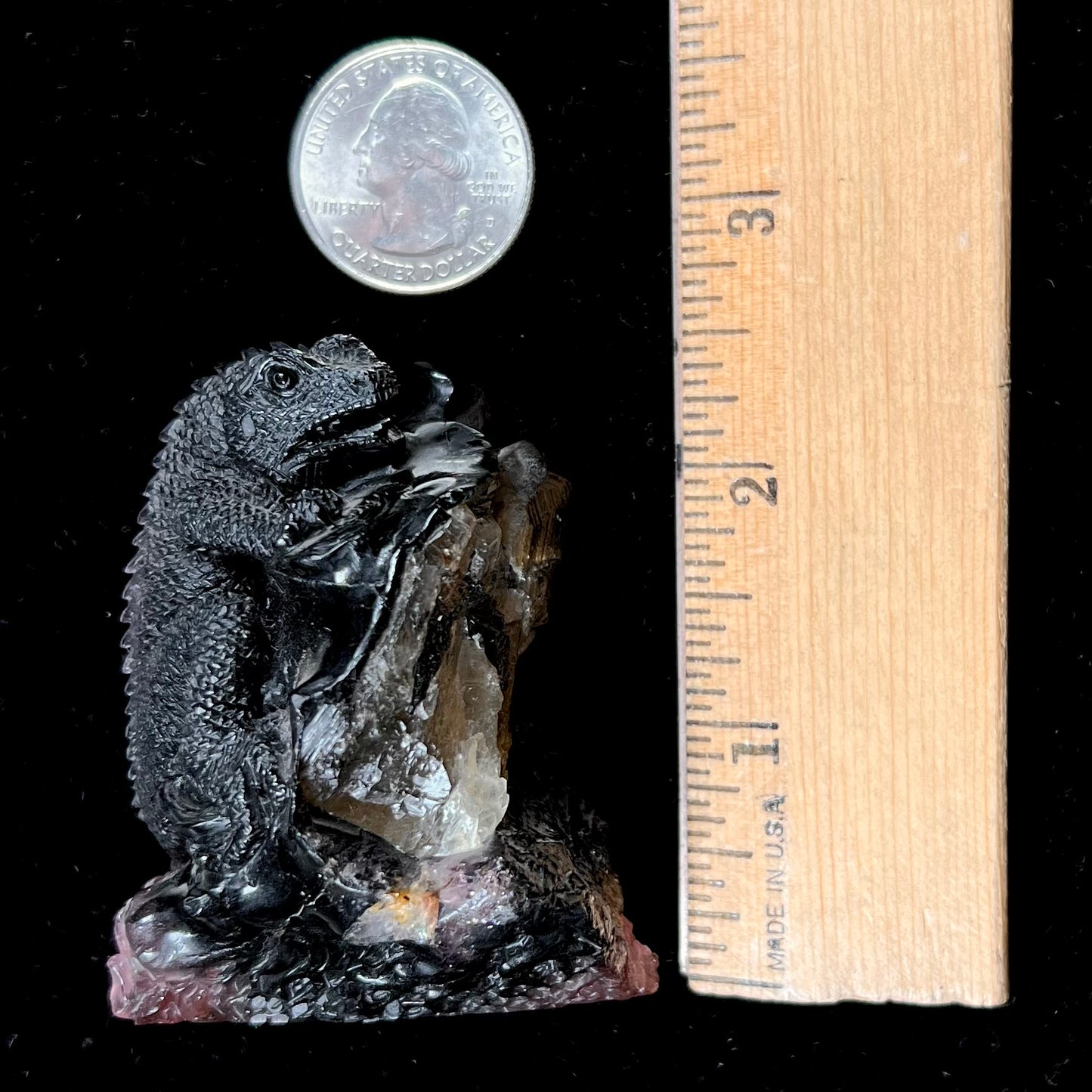 A stone lizard carved by artist, Ronald Stevens, from a liddicoatite tourmaline crystal.