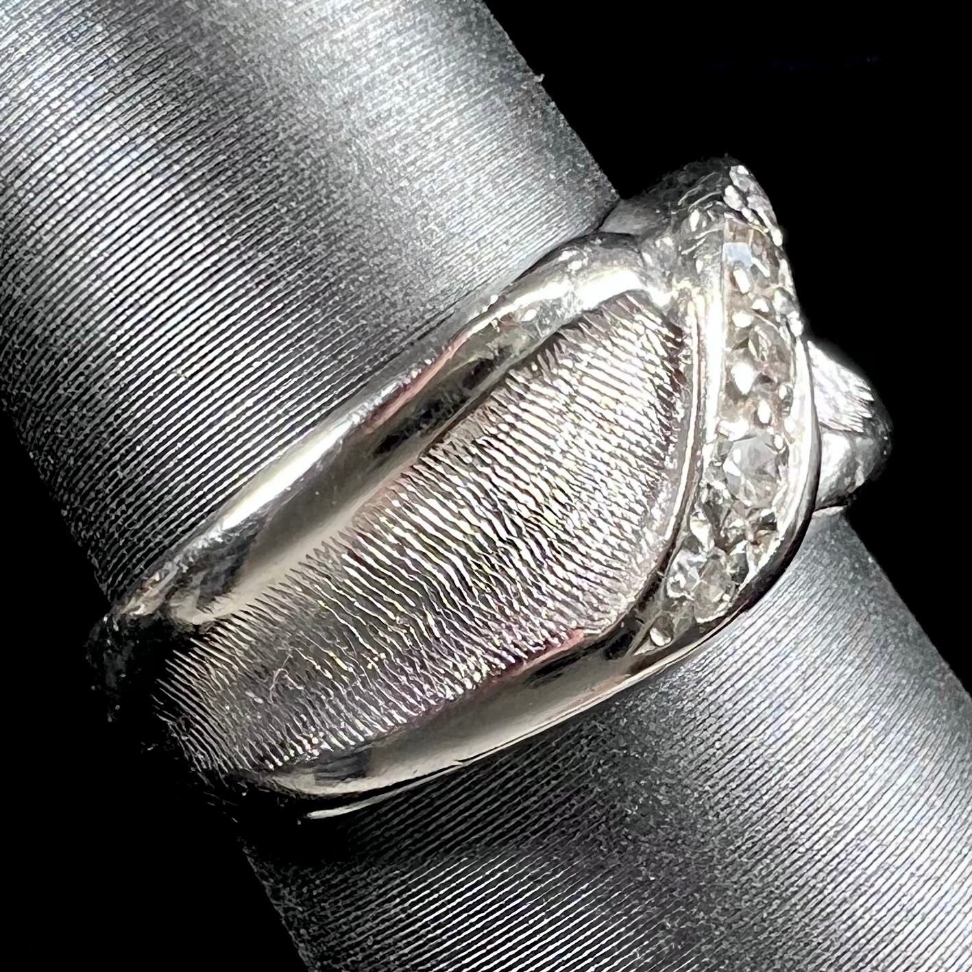 A ladies' white gold five stone single cut diamond ring.  The metal of the ring has a textured finish.