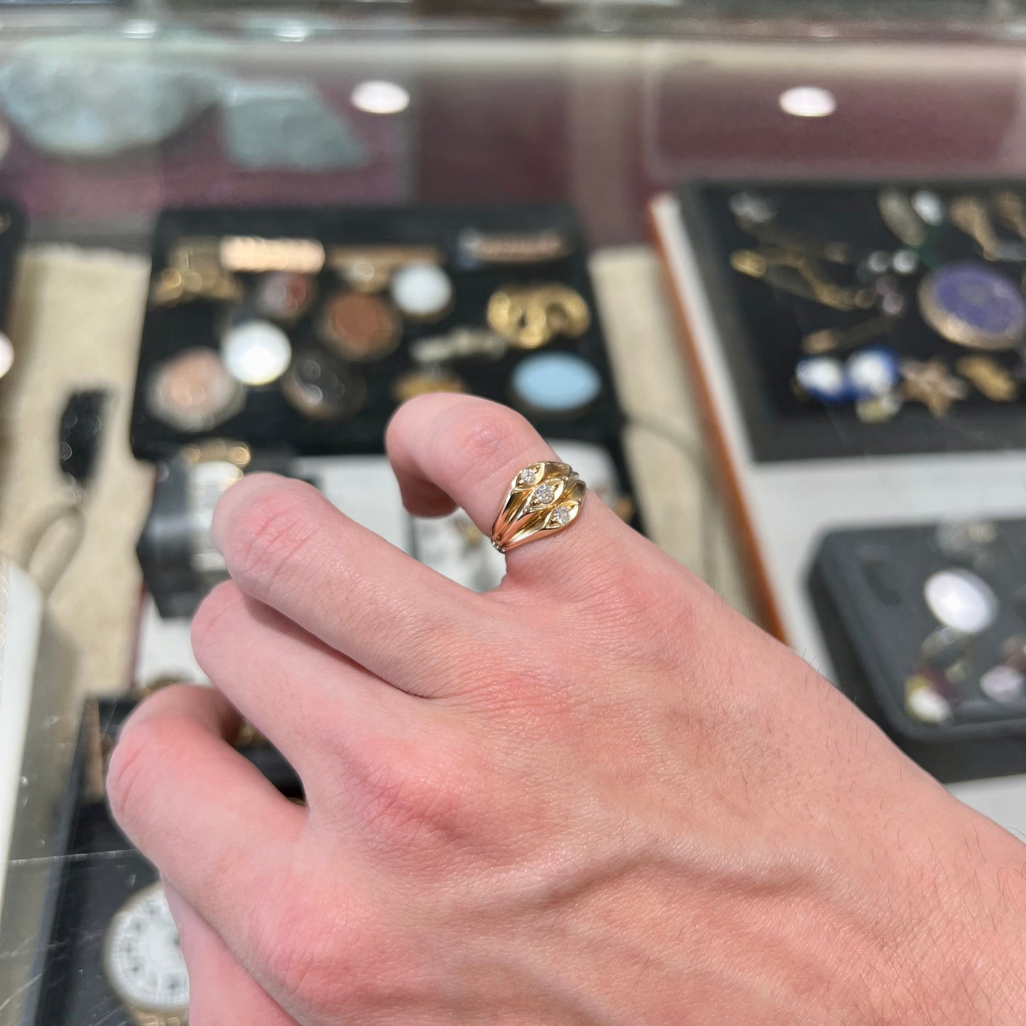 A vintage 1940's style ladies' yellow gold three stone diamond ring.