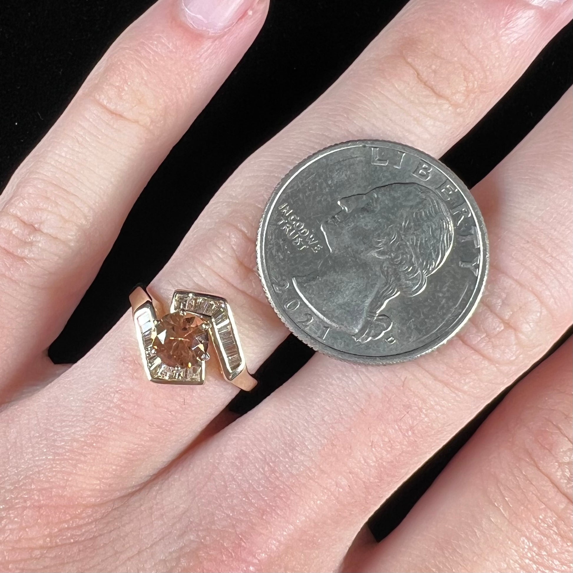 A yellow gold ladies' golden topaz ring set with baguette cut side diamonds.