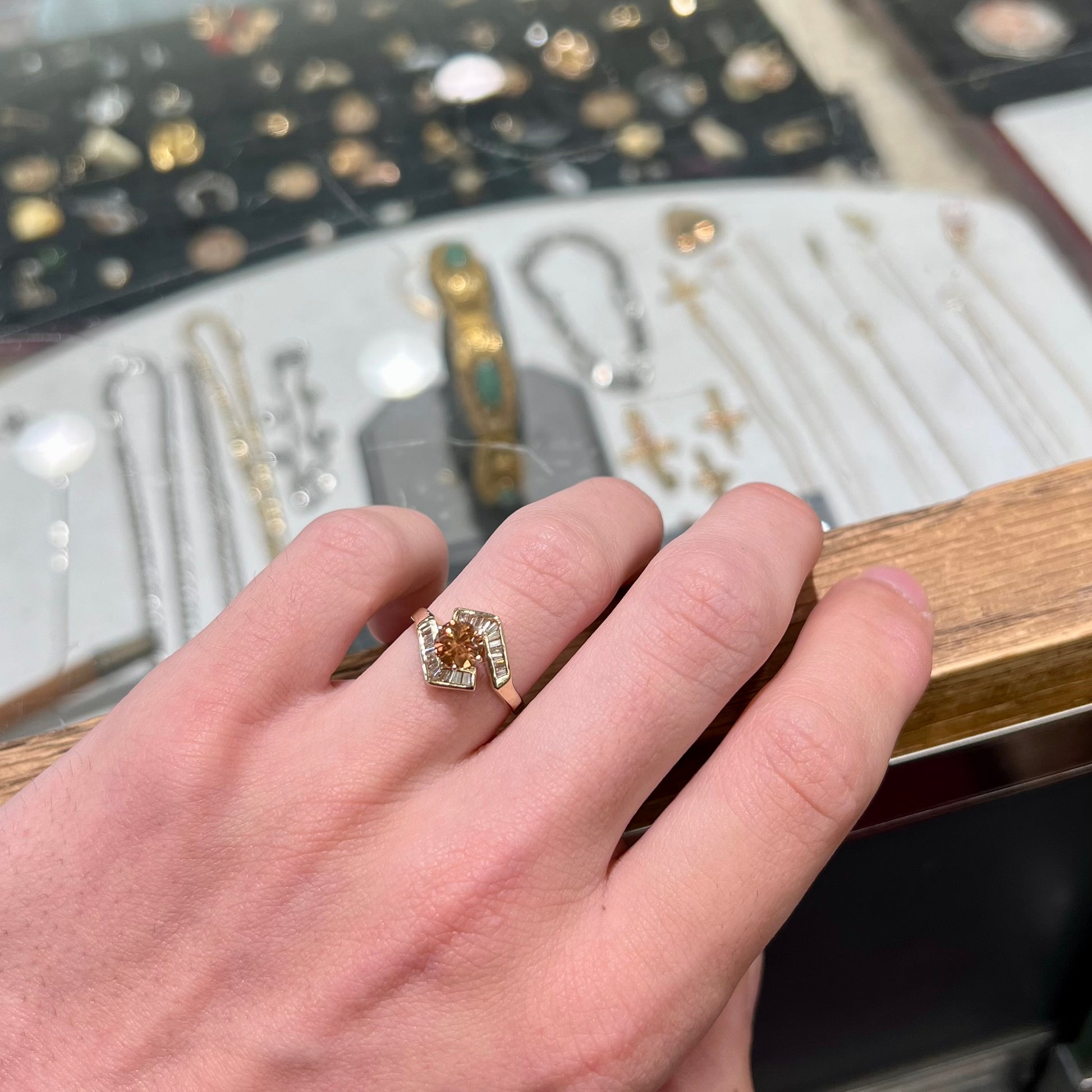 A yellow gold ladies' golden topaz ring set with baguette cut side diamonds.