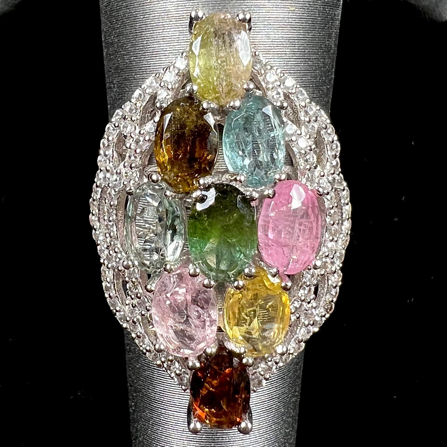 A silver gemstone cluster ring set with a rainbow of multicolored tourmaline stones.