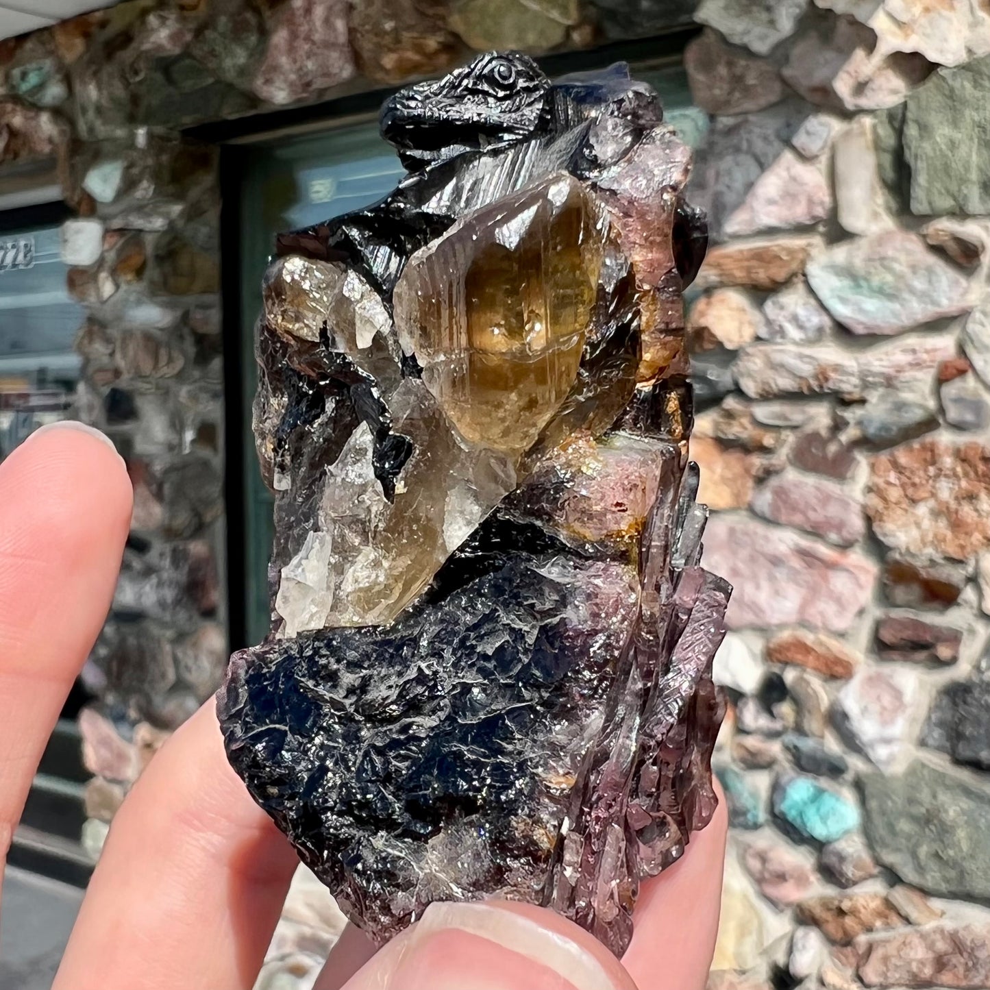 A stone lizard carved by artist, Ronald Stevens, from a liddicoatite tourmaline crystal.