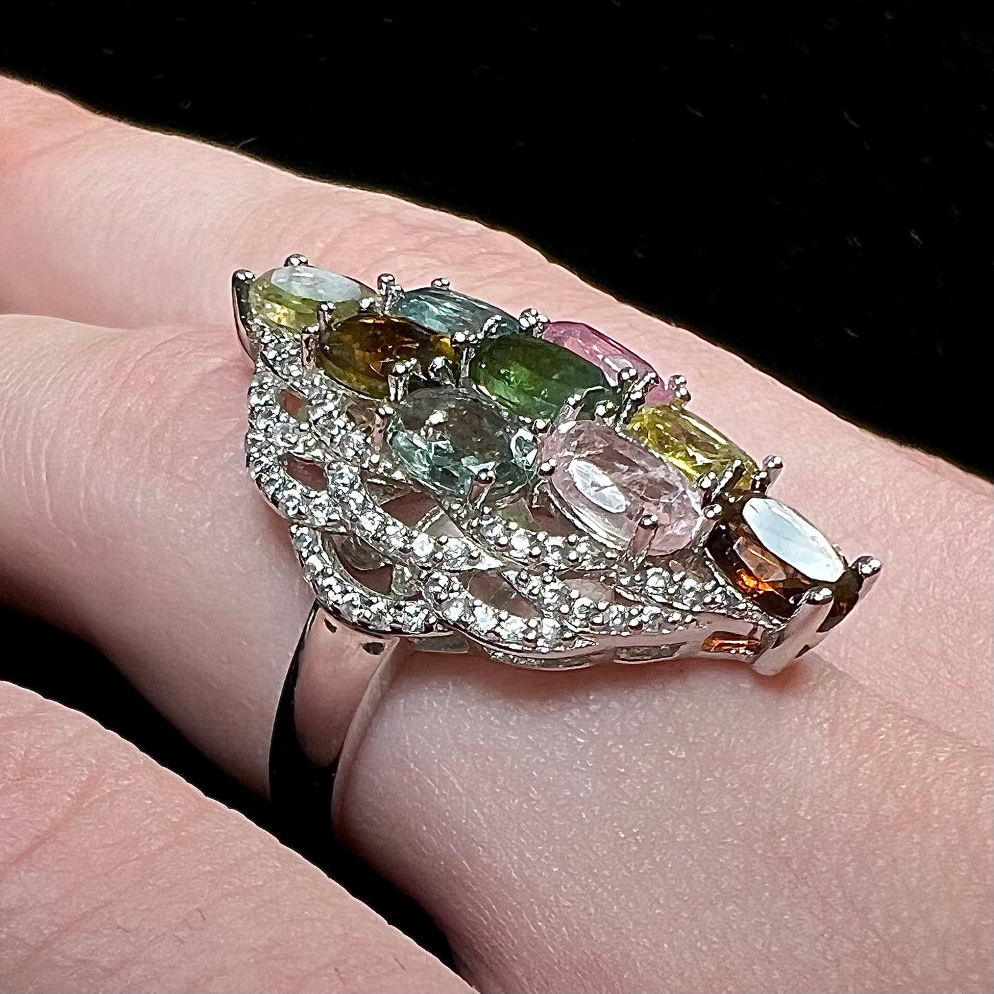 A silver gemstone cluster ring set with a rainbow of multicolored tourmaline stones.