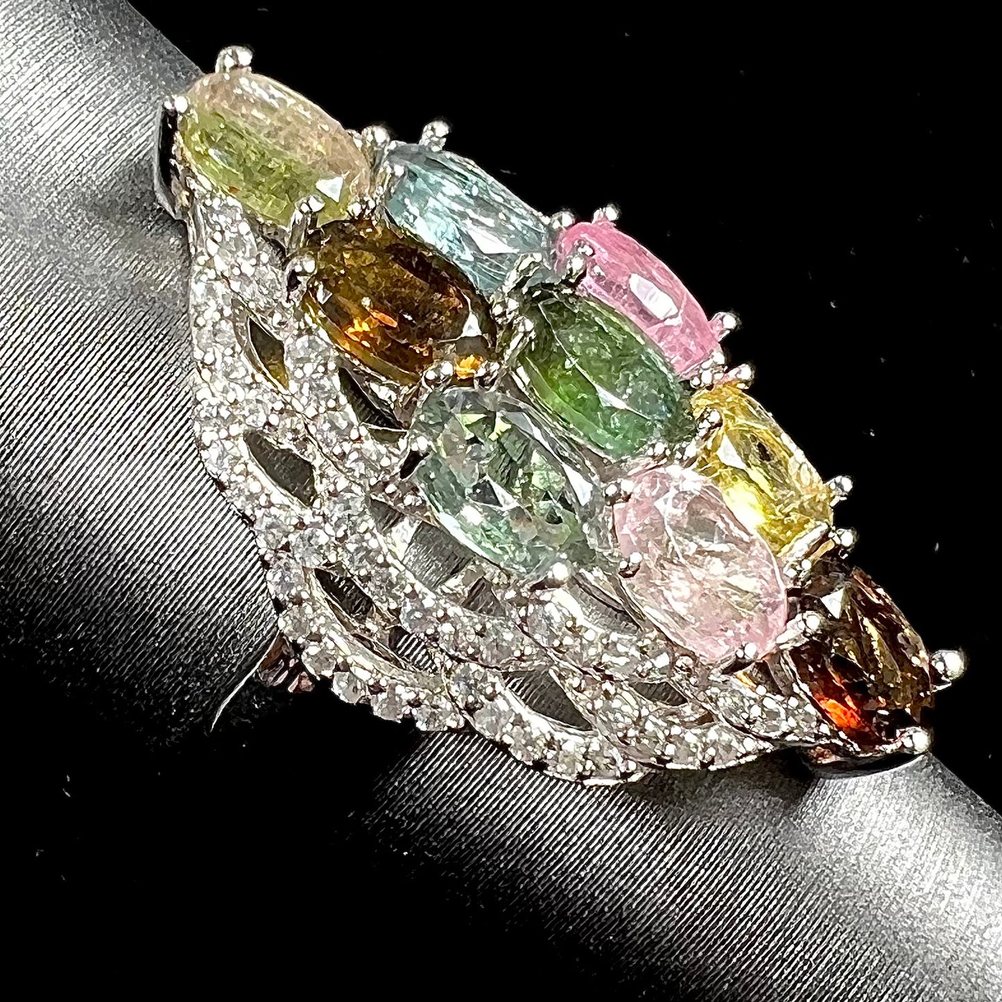 A silver gemstone cluster ring set with a rainbow of multicolored tourmaline stones.