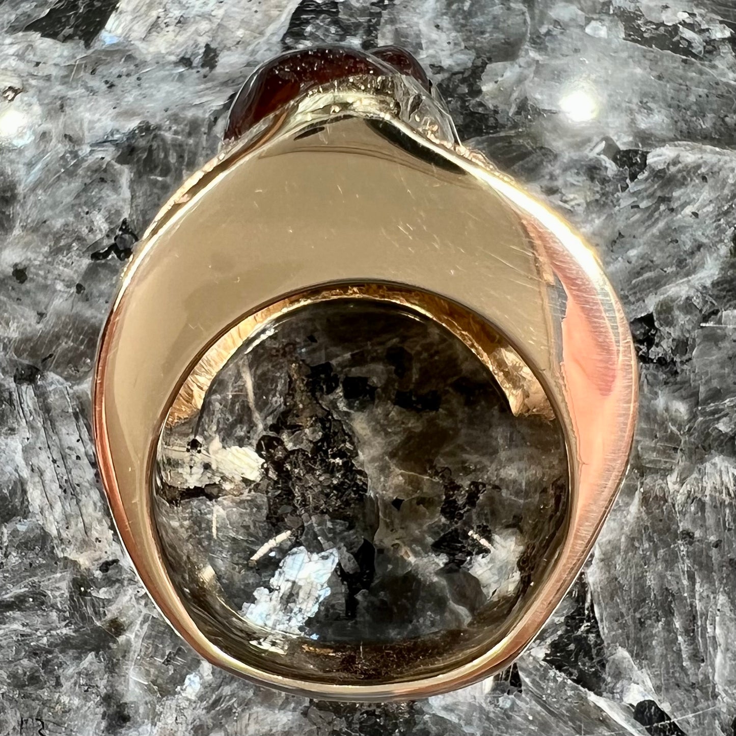 A large nugget style men's fire agate ring cast in yellow gold.  The fire agate is predominantly orange and green.
