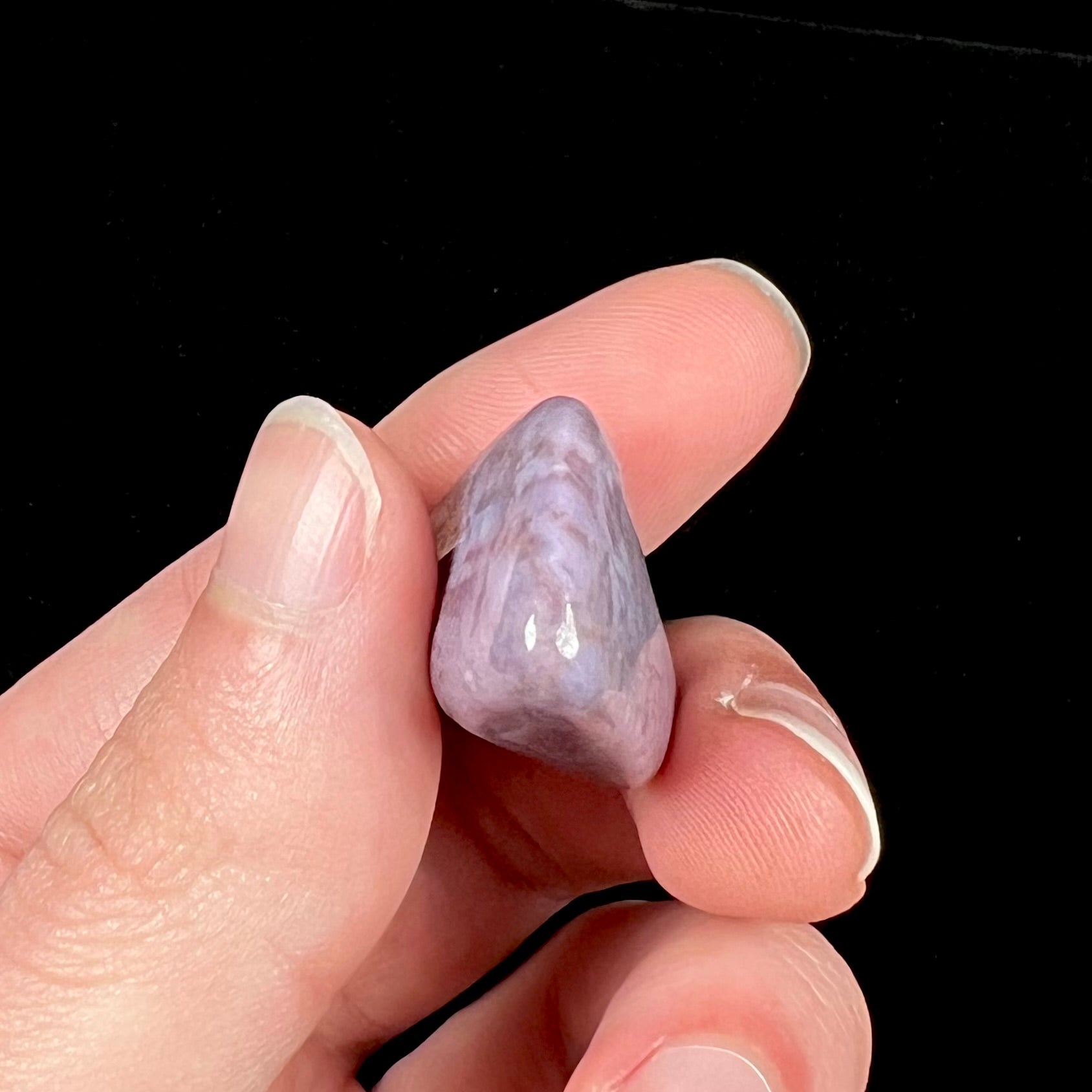 A tumbled purple turkiyenite jade stone from Bursa, Turkey.