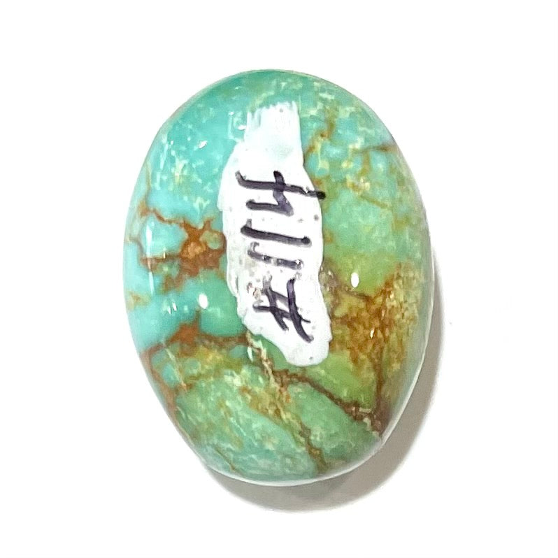 A loose, greenish blue turquoise stone with brown matrix from the Royston Mining District in Nevada.