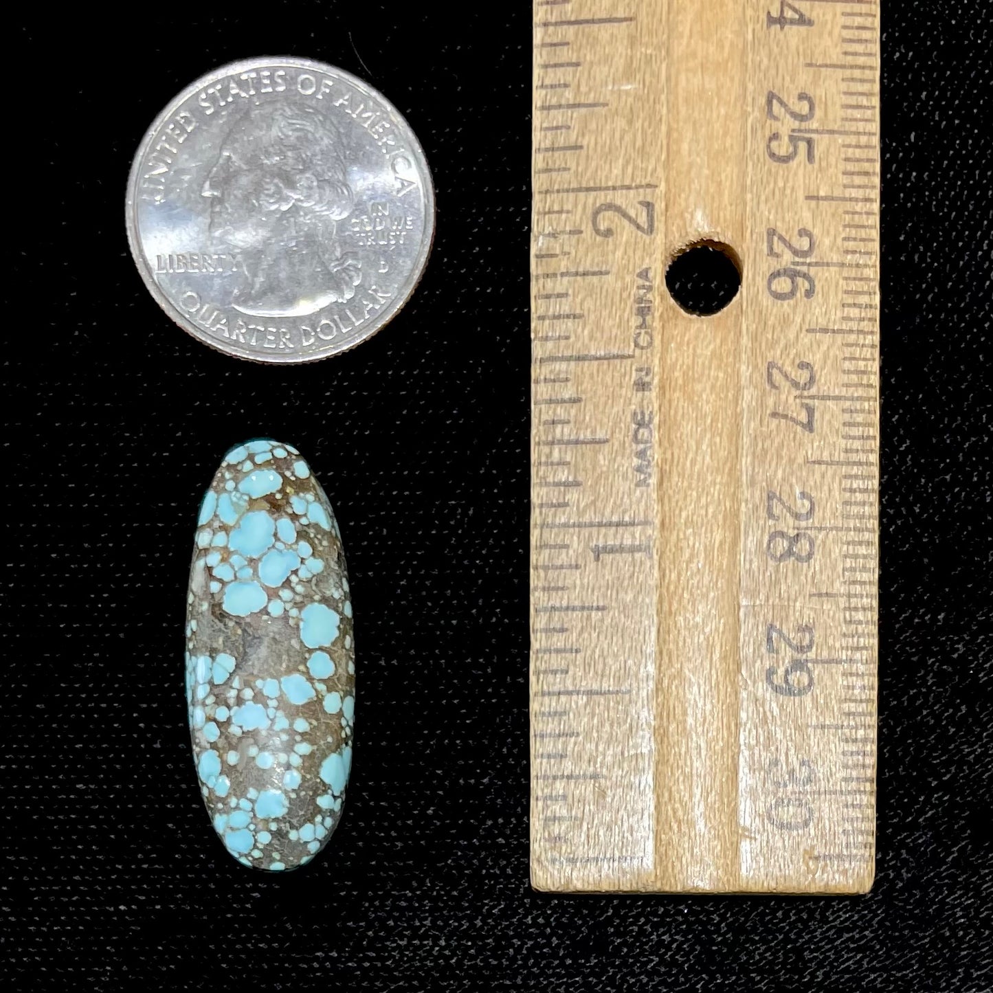 A loose, oval cabochon cut turquoise stone from the Number 8 Mine in Lander County, Nevada.