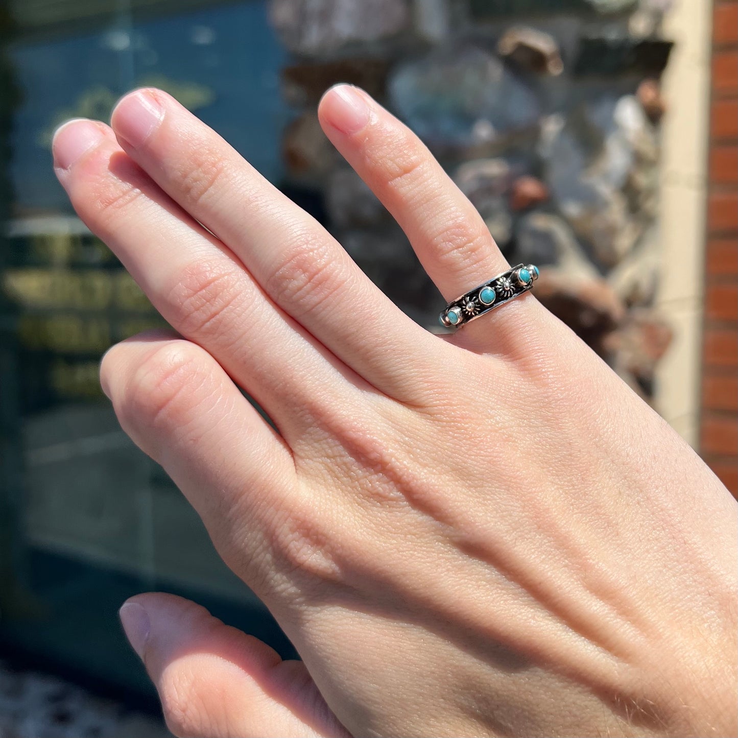 A sterling silver turquoise and flower design eternity band, made in Mexico.
