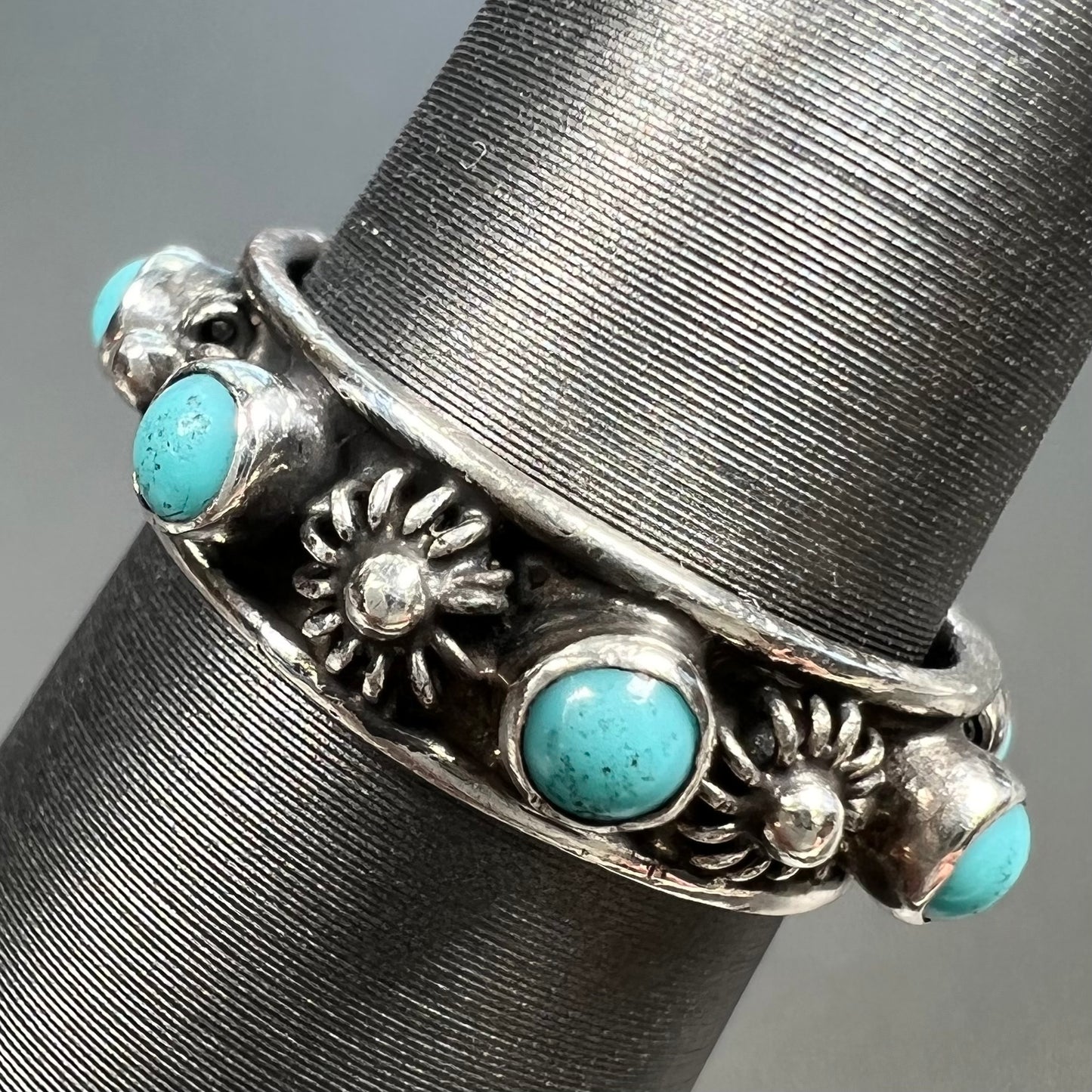 A sterling silver turquoise and flower design eternity band, made in Mexico.