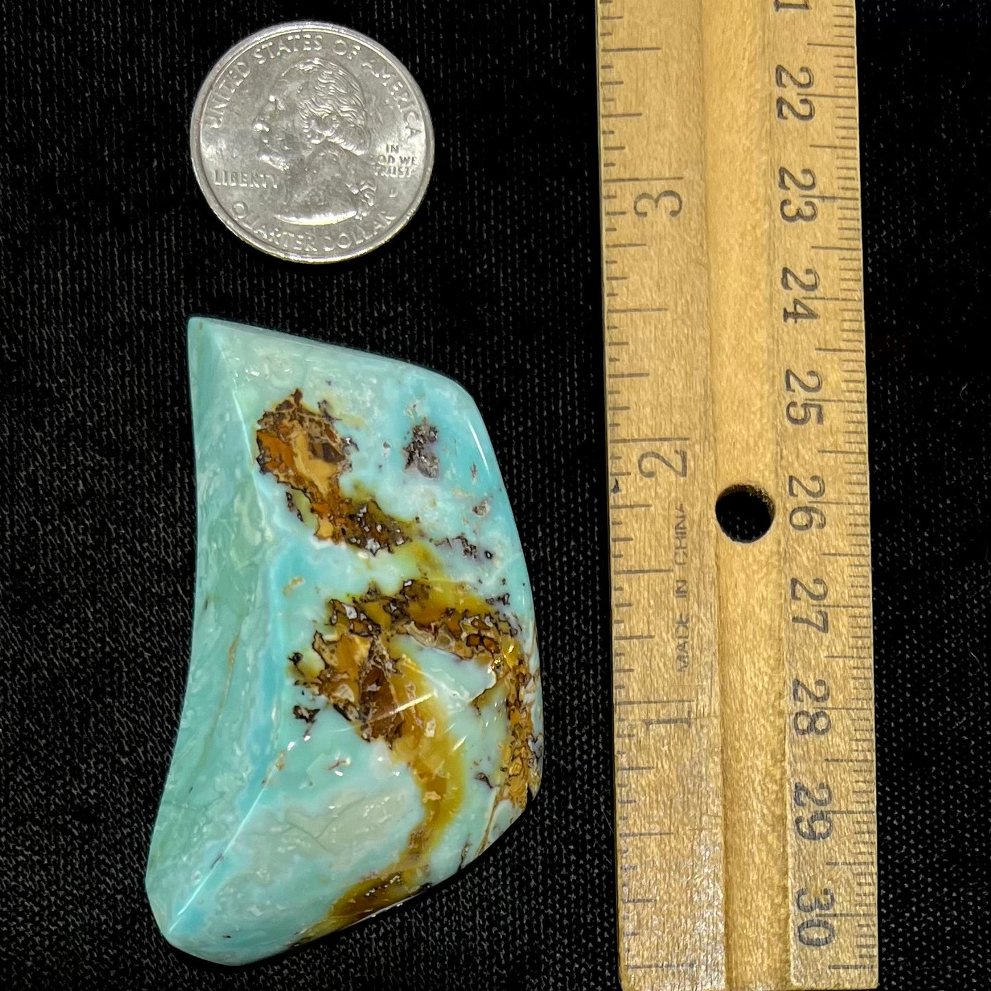 A polished, freeform shape light blue turquoise stone from Blue Gem Mine, Nevada.