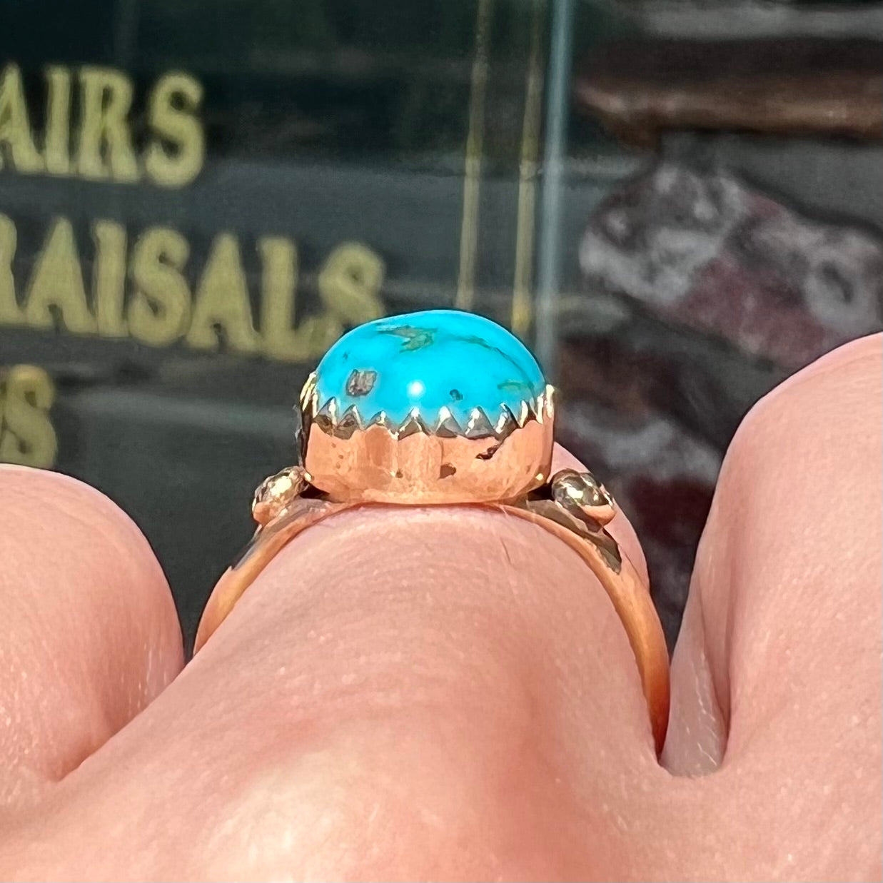 A ladies' yellow gold turquoise ring. The turquoise is a round cabochon cut.