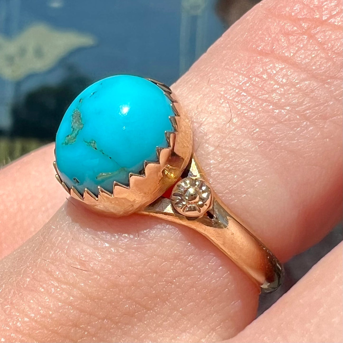 A ladies' yellow gold turquoise ring. The turquoise is a round cabochon cut.