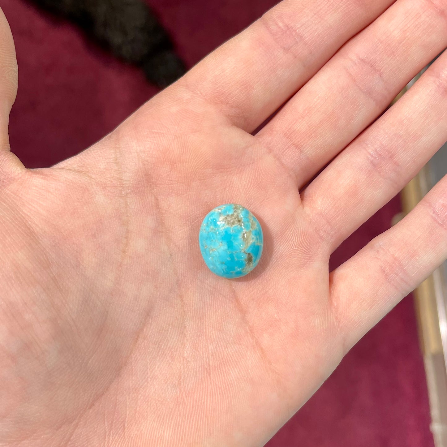 A loose, oval cabochon cut turquoise stone from the Sleeping Beauty Mine in Arizona.