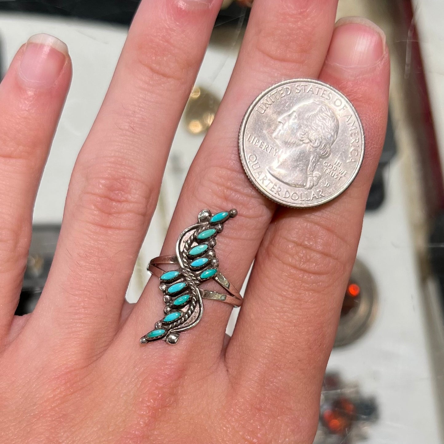 A Zuni needlepoint turquoise ring set in sterling silver.