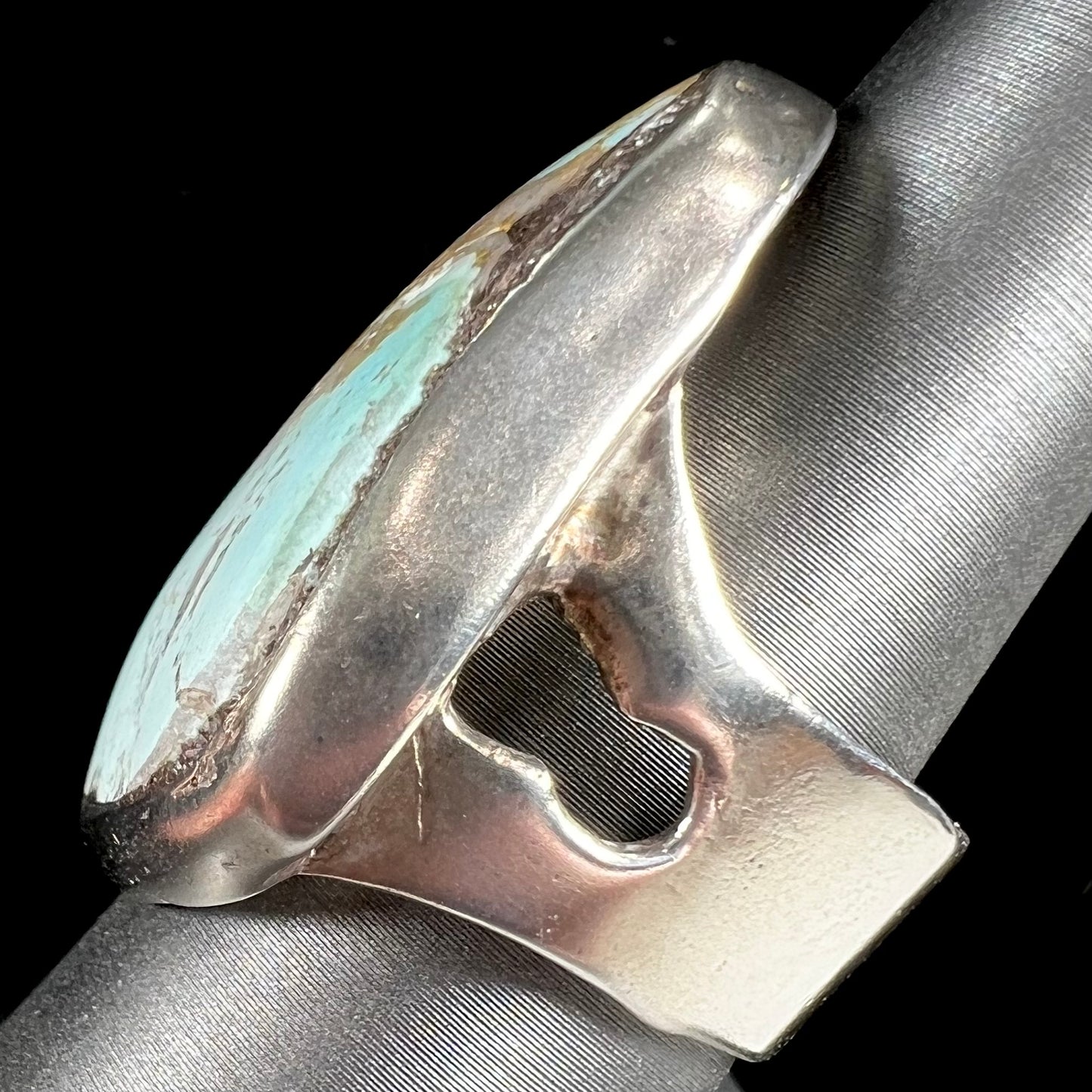 A men's sterling silver ring set with a powder blue turquoise stone. The ring is rustic style.