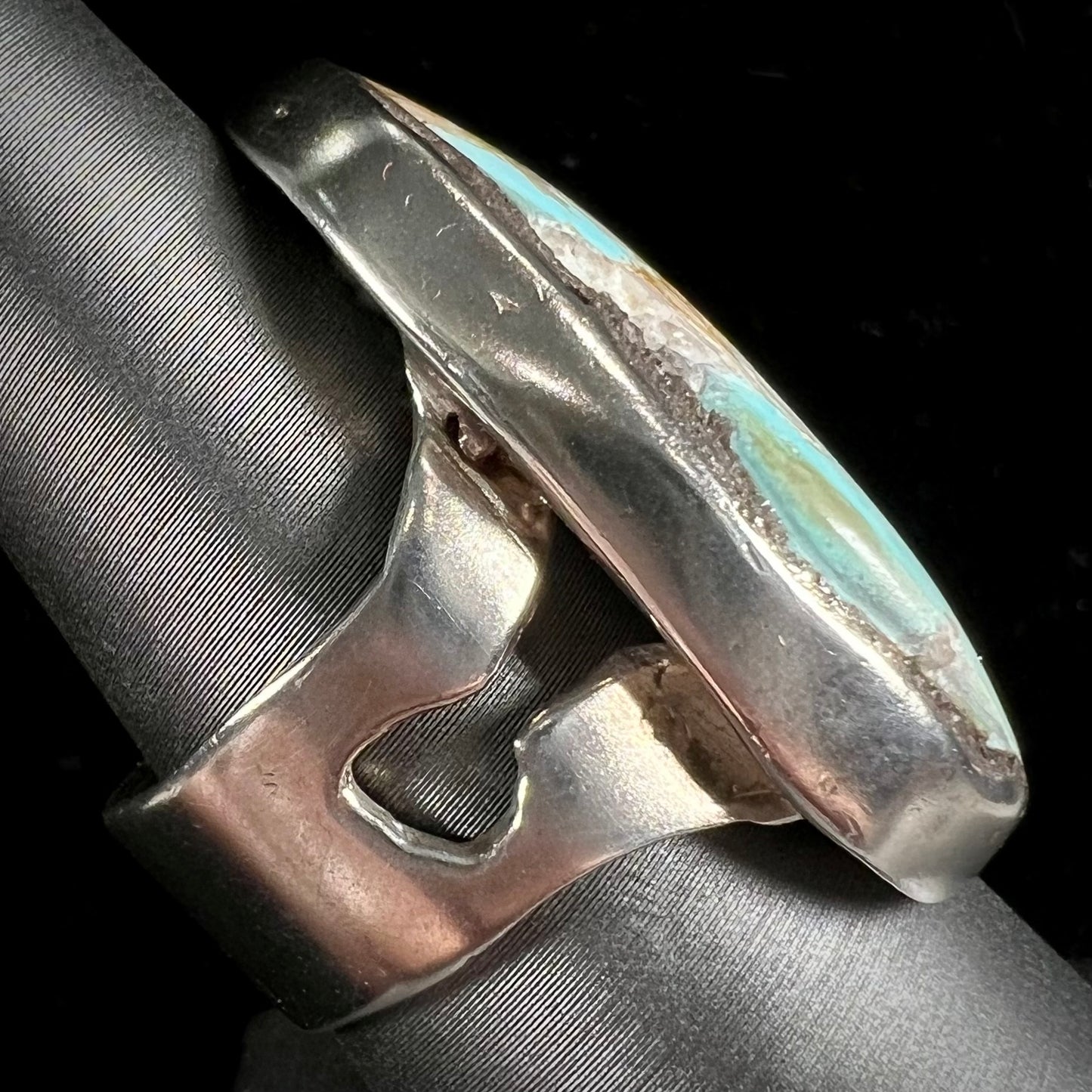 A men's sterling silver ring set with a powder blue turquoise stone. The ring is rustic style.