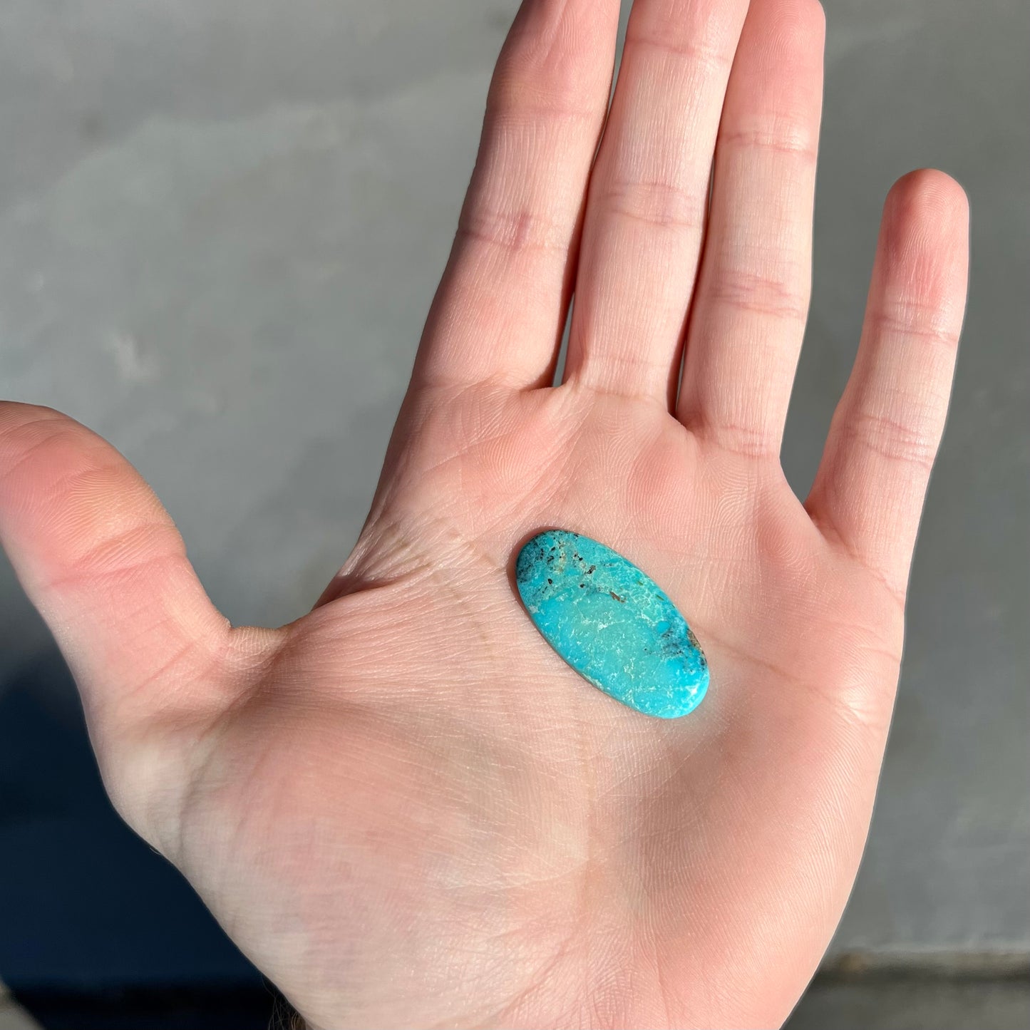 One loose oval cut blue turquoise stone from Bisbee, Arizona.