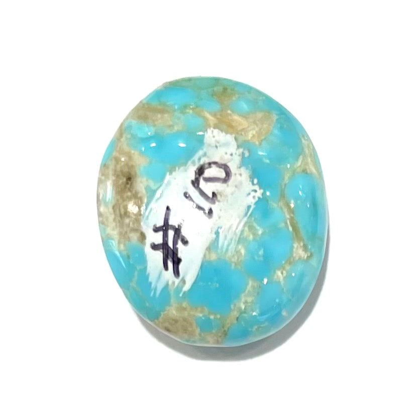 A loose, oval cabochon cut turquoise stone from the Sleeping Beauty Mine in Arizona.