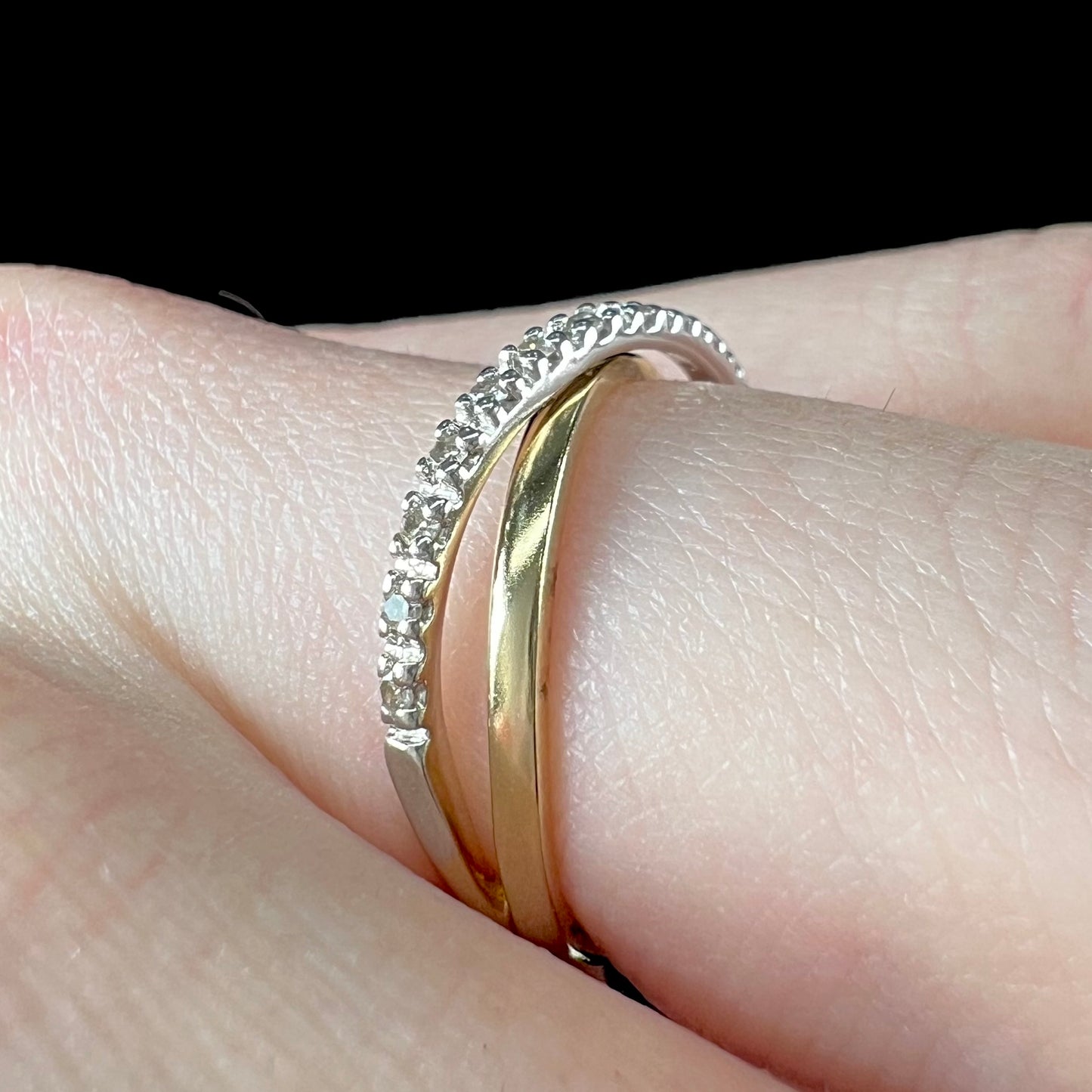 A ladies' two tone yellow and white gold twisted shank ring pave set with round single cut diamonds.