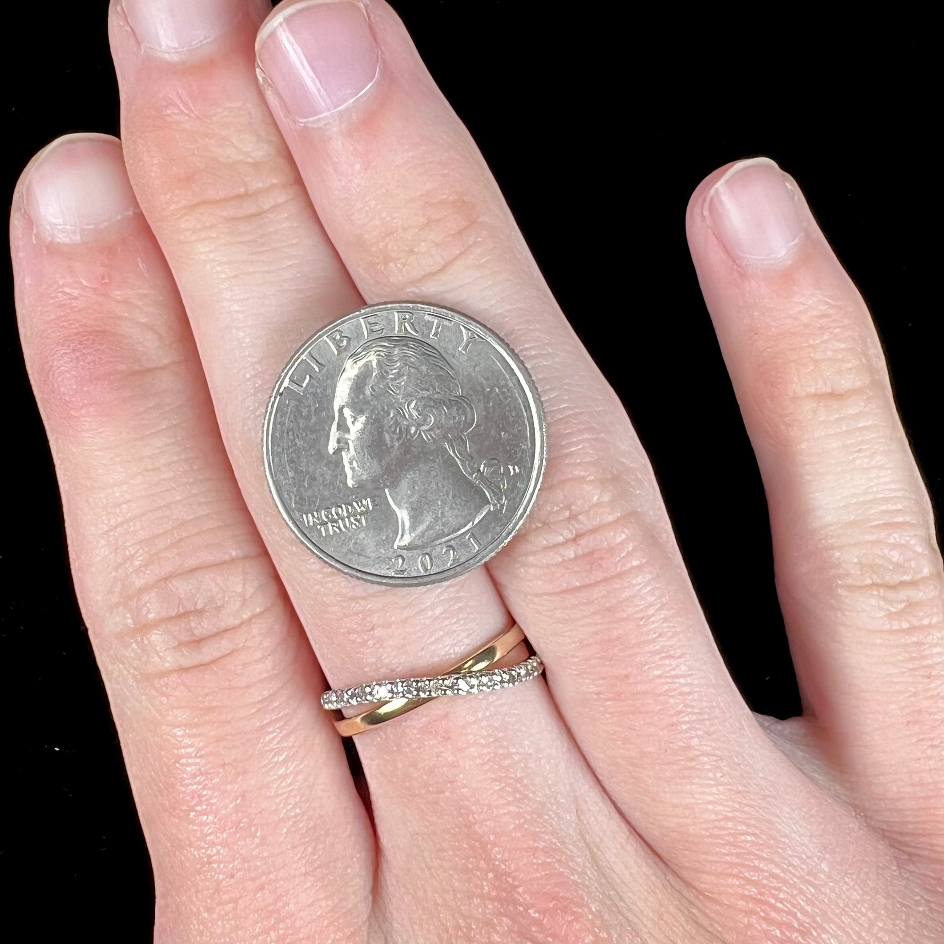 A ladies' two tone yellow and white gold twisted shank ring pave set with round single cut diamonds.