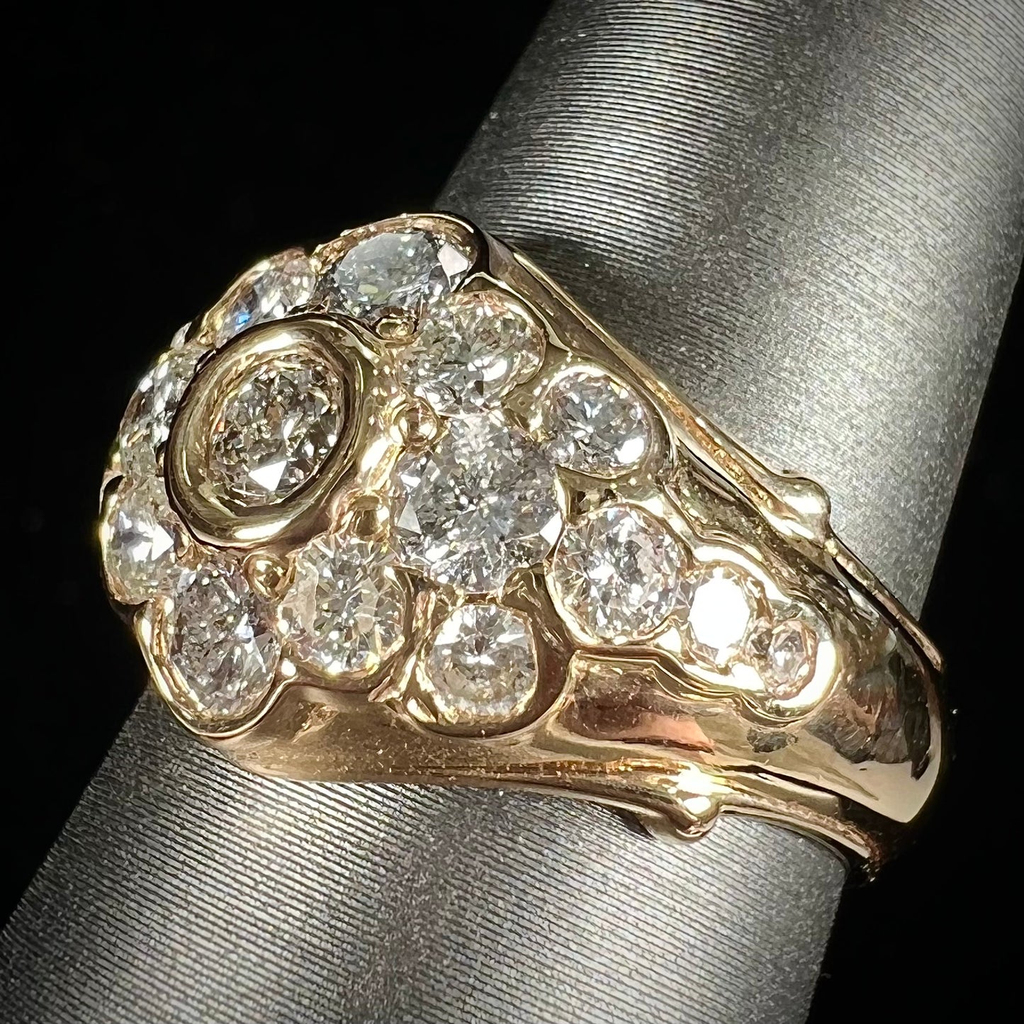 A yellow gold domed diamond ring set with 19 Standard Round Brilliant Cut diamonds.