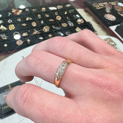A unisex 18k yellow gold diamond ring pave set with round single cut diamonds.