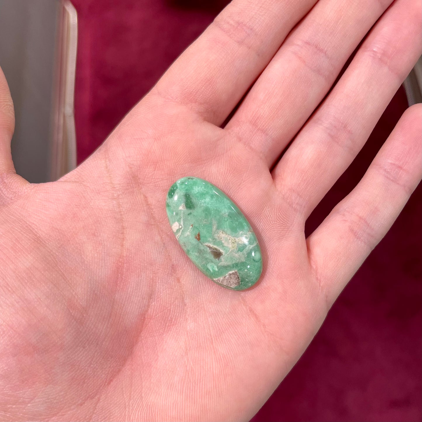 A loose, oval cabochon cut variscite stone from Utah, USA.