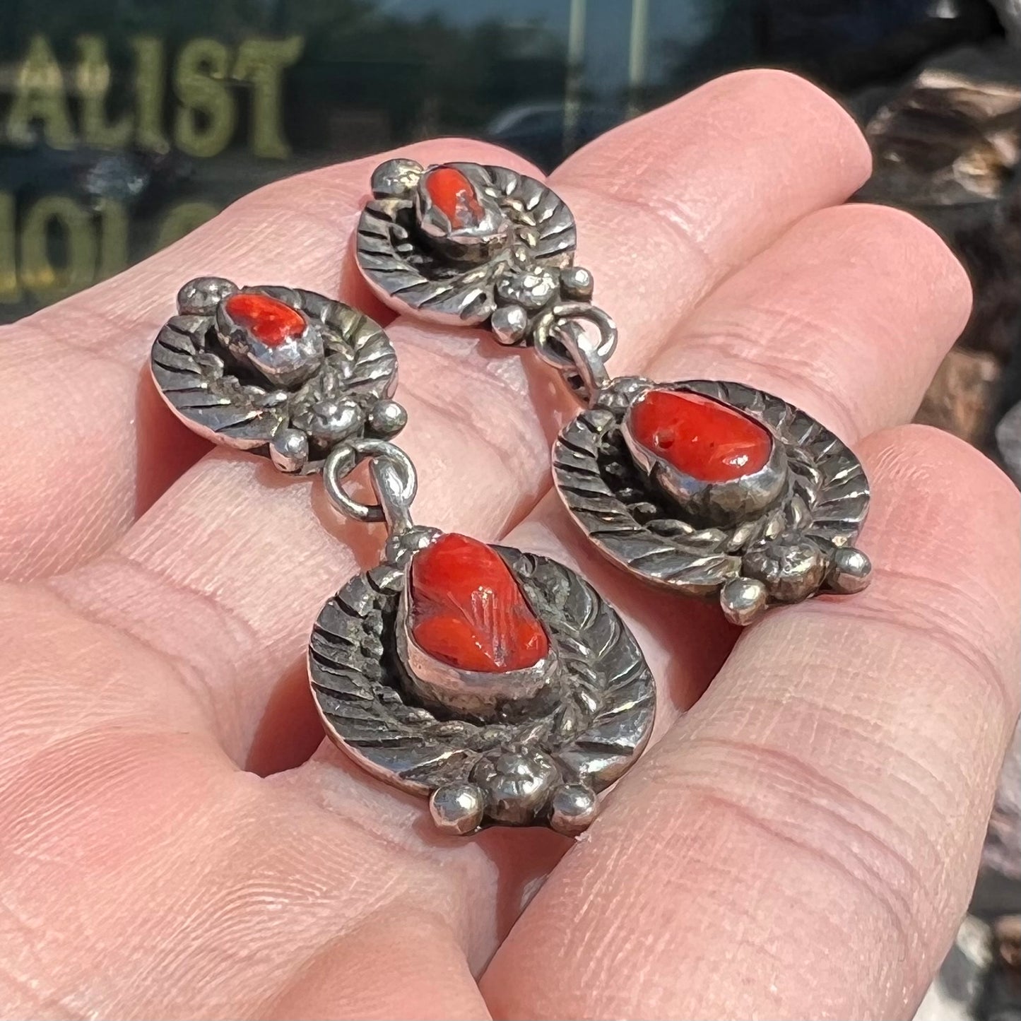 A pair of vintage coral branch dangle earrings handmade by Navajo artist, Delbert Chatter.