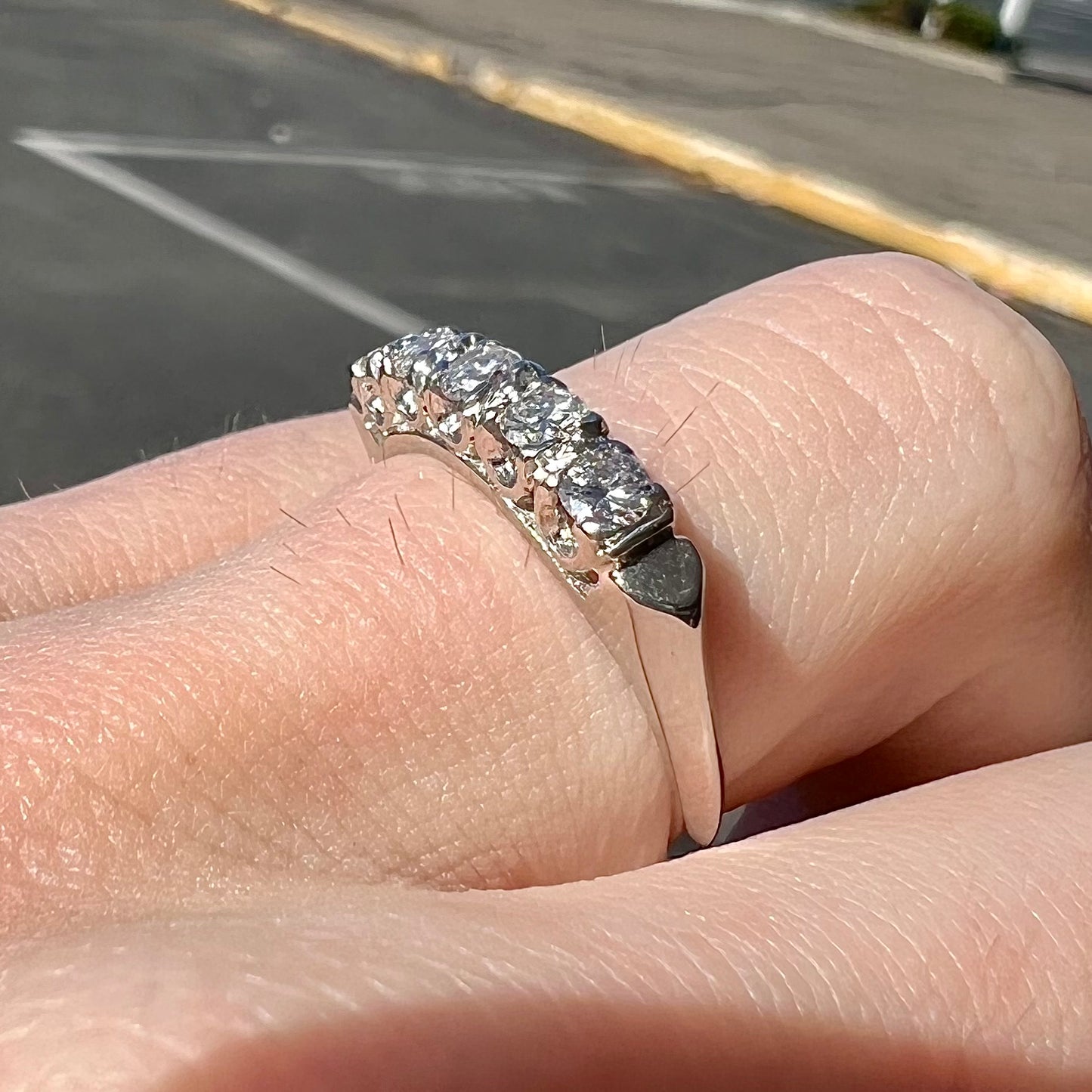 A vintage style ladies' platinum wedding band set with five round diamonds.